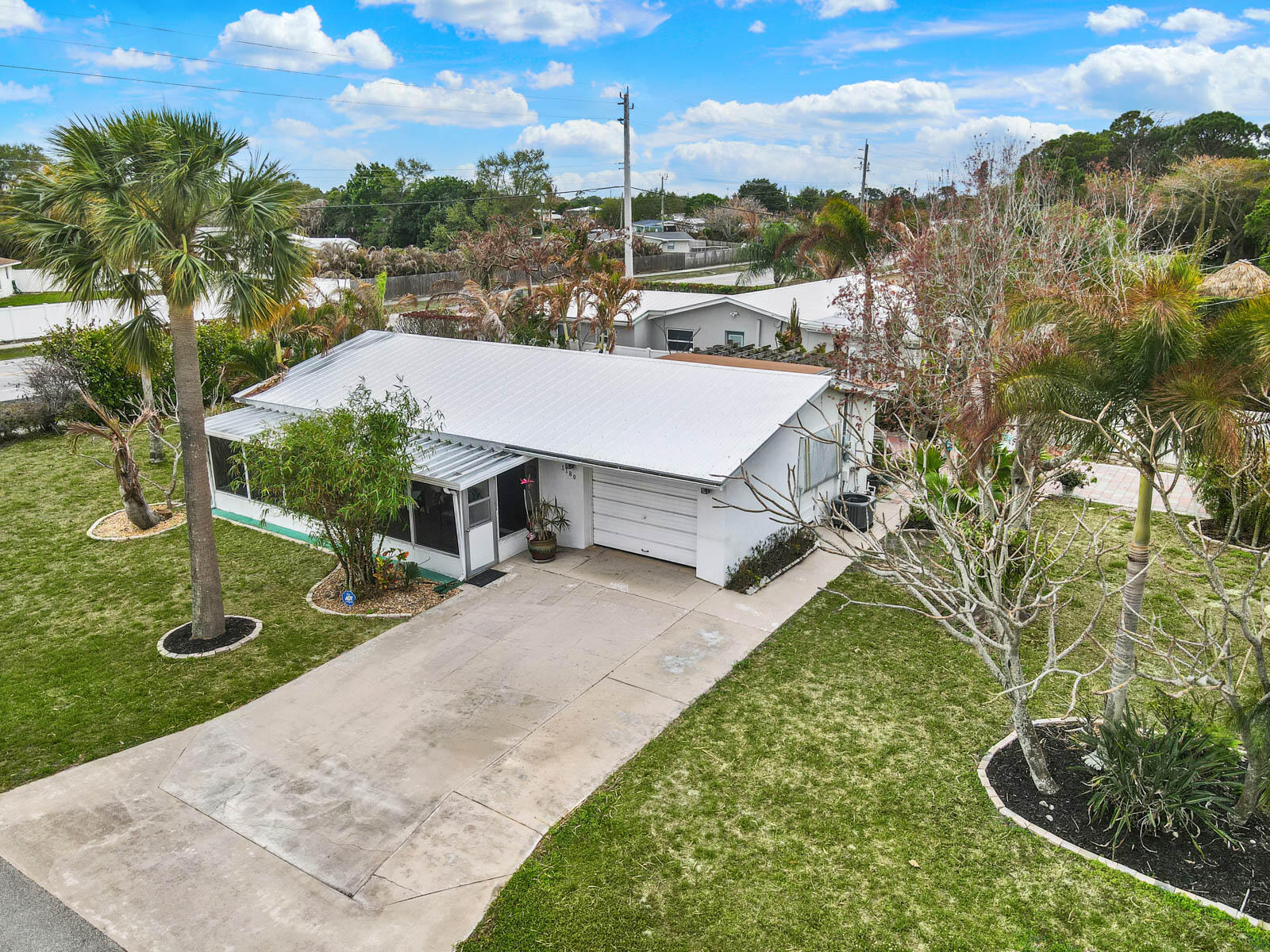 Motivated Seller! Corner lot - Room for your boat AND RV. No HOA. WALK to Downtown Jensen Beach! This charmer is move-in ready — brand-new HVAC with all-new ductwork and a durable metal roof and impact windows mean big-ticket items are already DONE. This 2/2 with den - layout is efficient and full of potential! The spacious, tree-shaded corner lot truly sets this property apart. Bring your toys, entertain under the canopy, and enjoy the privacy that oversized lots like this simply don't offer anymore. Zoned for Jensen Beach's top-rated schools and just a short stroll to Downtown Jensen's waterfront dining, boutique shops, and the beloved Jammin' Jensen events. You're not just buying a home — you're buying into one of Florida's most authentic coastal communities. Schedule a showing today.