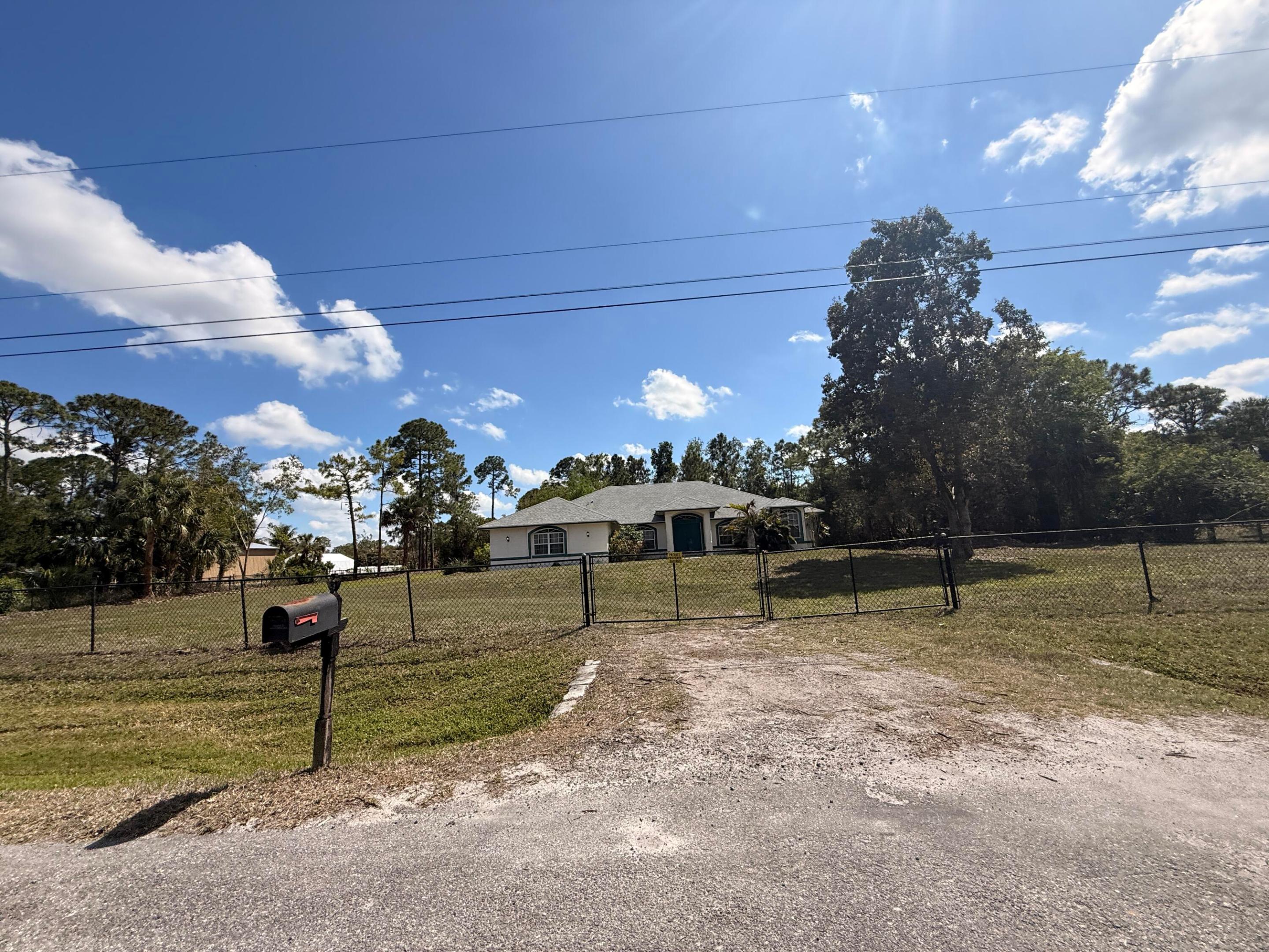 Opportunity knocks in the heart of The Acreage! Situated on a beautiful 1.31-acre lot, this 3-bedroom, 2-bath CBS home offers approximately 2,485 living square feet and endless potential for the buyer ready to make it their own.  Featuring a desirable split-bedroom floor plan, spacious living areas, and plenty of room for vehicles, boats, RVs, animals, and all your toys, this property provides the privacy and freedom Acreage living is known for. A newer roof installed in 2023 adds significant value and peace of mind.  The home is in need of updating and repairs, making it an excellent opportunity for investors, renovators, or buyers looking to customize a property to their personal taste while building instant equity.   Enjoy the benefits of no HOA, a highly desirable location, top-rated nearby schools, and plenty of space to create your dream outdoor oasis. Whether you're looking for a primary residence, investment property, or renovation project, this property offers exceptional potential at a compelling value.  Bring your vision and unlock the possibilities this Acreage gem has to offer!