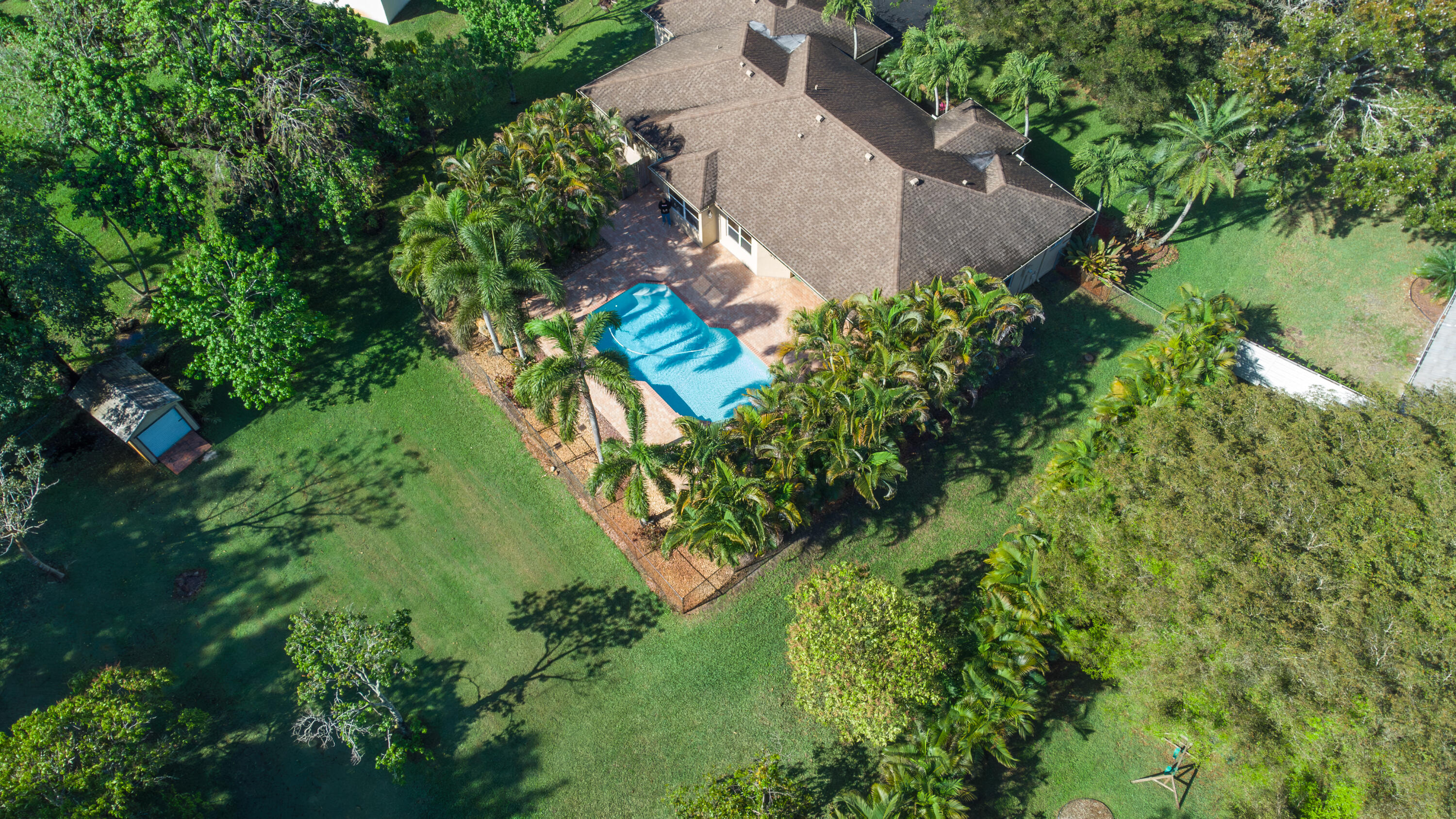 Beautifully maintained four bedroom pool home perfectly located in a very diserable area of Pembroke Pines sitting on a builder's acre. The home features 42" wood kitchen cabinets finished with crown moldings. The AC was replaced in 2023 with a ten year transferrable warranty and the roof replaced in 2013. The oversized main bedroom features a private entrance on to the pool patio and has two walking closets. The split bedroom floor plan offers three spacious guest bedrooms all with large closets. The pool and heated spa privately located in an oasis was diamond brite resurfaced in 2026 and a new spa heater installed. The oversized patio is perfect for entertaining, there is a hot and cold wash down outdoor shower and ample space to bar-b-que. The interior was freshly painted in 2026.  The lot has a zoned sprinkler system and an outdoor shed. The lot extends an additional 50 feet beyond the fence. There are Miami Dade approved hurricane shutters. There is a generator hook up in the garage wired to power the house. The road is a new freshly paved deadend road, with no through traffic. No HOA and A-rated schools. Beautiful opportunity it is a must see!