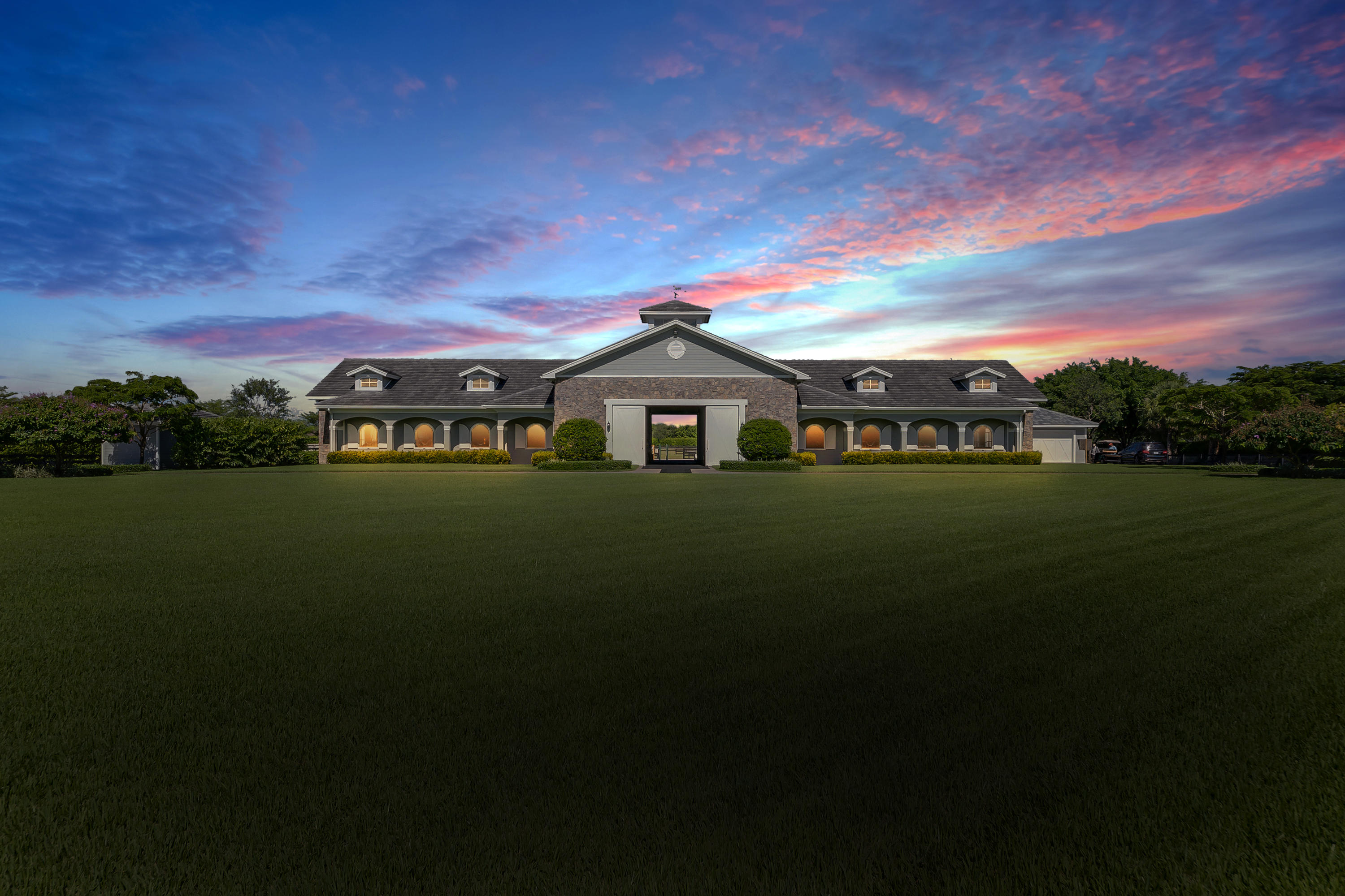 This 5 acre, meticulously maintained property is perfectly located in the heart of all Wellington horse events.  A perfect tree lined cobblestone driveway frames an acre grass field which can accommodate a large home. The functional horse farm features 12 stalls, 2 wash stalls and a prepping area, along with 4 paddocks and a sand ring.  The riding trail surrounding the paddocks is a step away from the bridle path overlooking International Polo Club. Ride to Global Dressage or to Polo.
Owners lounge with full bath, a 2 Bedroom|1 Bath Apartment & 2 Guest Bathrooms complete the living areas of the barn.  Barn has tack room, feed room, laundry room, impact glass windows, wood features throughout. *New GT footing in place*

Secluded, private, boasting an ideal location for all horse enthusia New GGT in place!