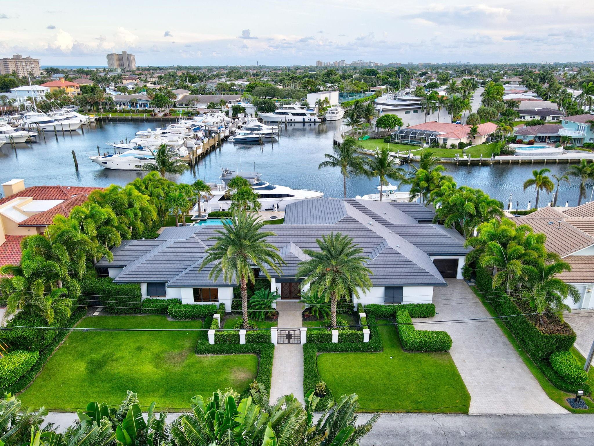 A Yachtsman’s dream! Gorgeous Deepwater estate facing south along the North Grand Canal in LHP. Boasting 135 feet of WF w/ mega yacht dockage, 15k boat lift, a huge turning basin & ample depth; perfect for large vessels and a tender. This sprawling, single-level 4 bed/ 4 bath sits on a 15,600 sq ft lot, is timeless in design, features lush manicured landscaping and boasts an expansive resort-style pool overlooking the LHP Yacht Club. Perfect for entertaining, the outdoor lanai is equipped w/ bar, built-in BBQ & fireplace along with the dockside firepit. The gourmet chef’s kitchen, comfortably chic living areas, and a luxury Primary suite create a warm sophisticated atmosphere. Nearly every room showcases beautiful water views which creates the ultimate South Florida WF living experience! Located just minutes from the Hillsboro Inlet and nestled in a protected enclave off the ICWW