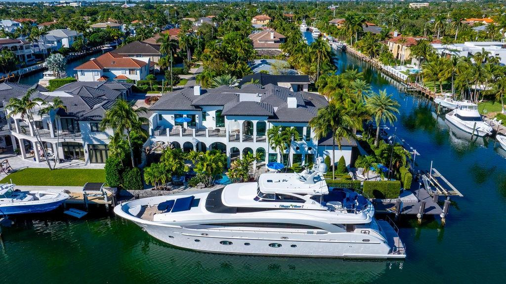 The ULTIMATE YACHT HOME BASE in Lighthouse Point! Completely redesigned and remodeled in recent years, this stunning waterfront estate offers dockage for up to a 145’ yacht plus an additional 135’ with three boat lifts for tenders and toys, all less than a 5-minute cruise to open ocean. The home features 5 bedrooms plus office and theater, 6 full baths and 1 half bath. A spectacular new kitchen with island and state-of-the-art appliances opens to the family room and breakfast area. VIP suite on the first floor, expansive primary suite upstairs with sitting area, and three additional ensuite bedrooms. Incredible outdoor living includes a huge covered patio with summer kitchen, fireplace, cabana bath, resort-style pool with water features, multiple seating areas, fountains, and fire pit.