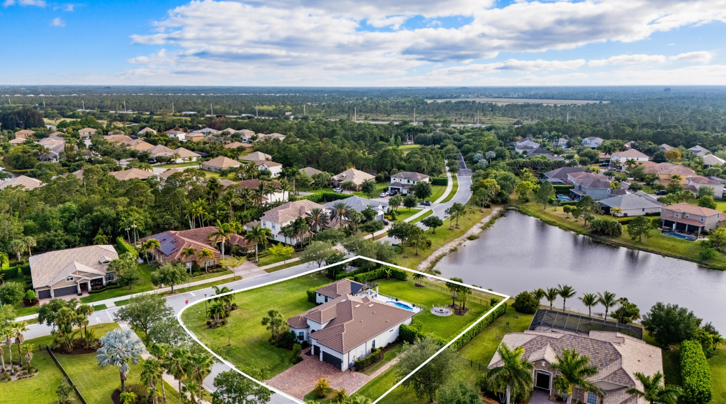 A rare offering in the sought after community of Copperleaf, this four bedroom, four bath residence with private office sits on over half an acre & has been thoughtfully elevated throughout, including a 2022 in law suite addition designed for privacy & flexibility. Full impact glass & doors, a buried 500 gallon propane tank pre plumbed for a future whole house generator, & a 2020 heated saltwater pool overlooking serene lake views The chef's kitchen is beautifully appointed with 2021 KitchenAid appliances, a 42 inch built in refrigerator, gas cooktop, ice maker, refined backsplash, & curated designer fixtures.  Zero corner sliders open seamlessly to a covered lanai with remote screens, creating effortless indoor outdoor living. The private in law suite offers a cabana bath, secluded lanai, pergola with swings, built in bar, & a premium Napoleon grill. An epoxied three car garage, firepit patio, outdoor shower, & custom tilework complete this turnkey, move in ready residence