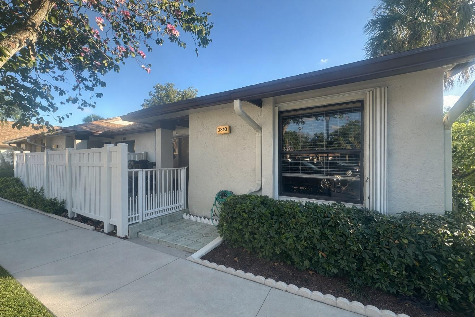This beautifully updated 2-bedroom, 2-bath corner-unit villa on the water features a versatile enclosed bonus room, ideal for a home office, den, or additional space for a toddler or teen. The home boasts ceramic tile throughout and a fully remodeled kitchen with stainless steel appliances and pull-out drawers. A new A/C was installed in 2024, and the roof was replaced in 2025. The property is equipped with hurricane accordion shutters in the front and roll-down shutters in the rear. Situated on a quiet cul-de-sac, the home offers a welcoming front patio perfect for relaxing or entertaining, and a back view of the water.The HOA includes cable, trash, lawn maintenance, pest control, insurance, roof repairs, common areas, parking, and pool access.No rentals allowed.
