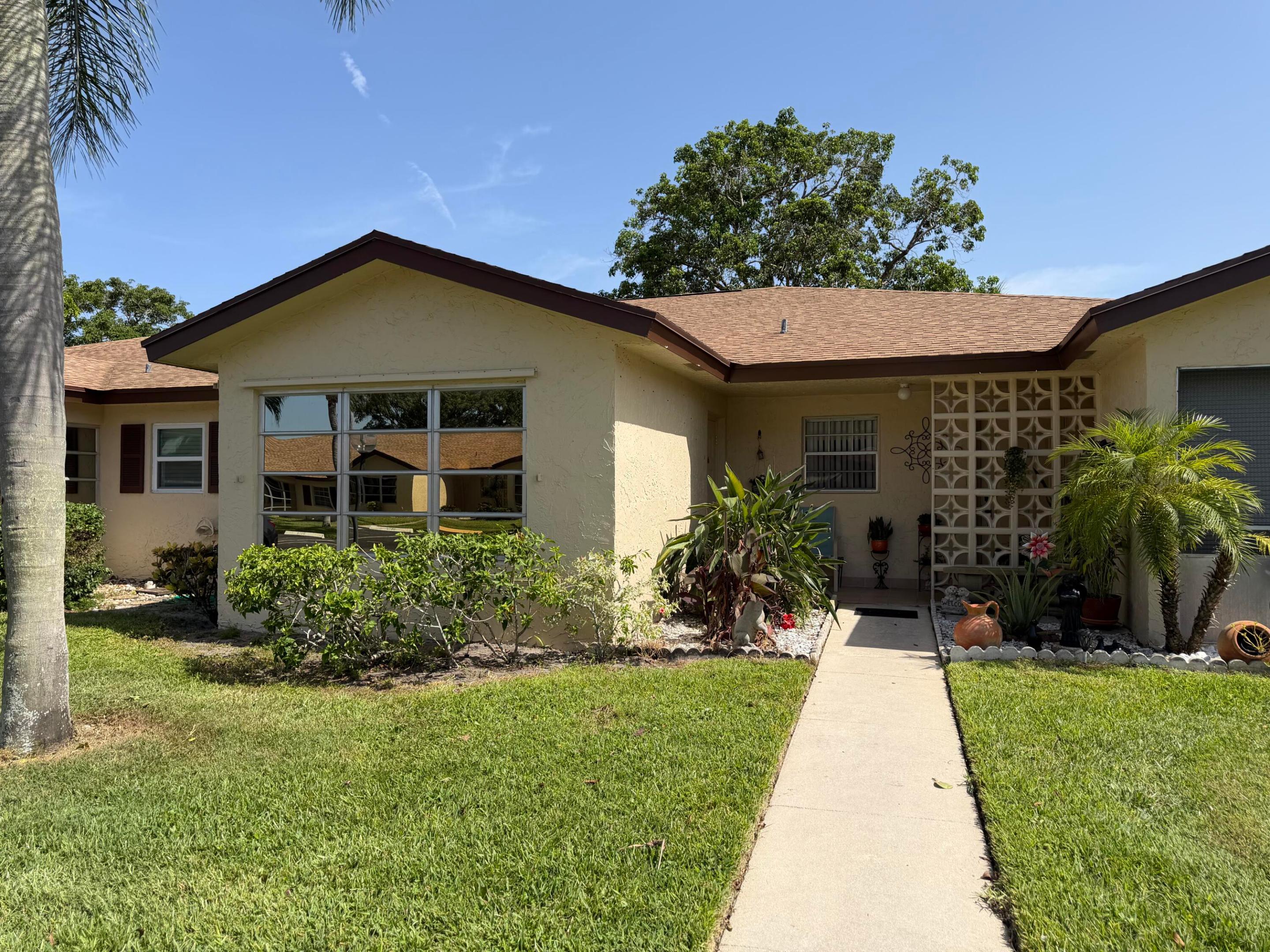 Great location of this well maintained 1Bedroom & 2 FULL Baths Villa. Nestled in a very active 55+ community. Villa Features: tile & Vinyl flooring throughout, with wood floors in Florida room. Florida room may be used as a den or second bedroom under air.  New roof in 2024, Newer A/C, with a stacked washer and dryer inside the villa, accordion shutter on master bedroom window, awning shutters for the front. Opened breakfast area with stools, Villa's back yard view is an interior canal with plenty of green space. Florida living at its best in this very active 55+ community where you'll find many planned social activities, enjoy game night, traveling, large heated resort style pool and clubhouse and so much more.   Located close to all amenities! Just minutes to the our award winning beaches and trendy downtown Delray where you'll find, quaint shops, open air cafes, fine restaurants, shopping malls, close to theaters, Golf Courses, International tennis center, new state of the art Library, close to I95/Turnpike, and places of worship.