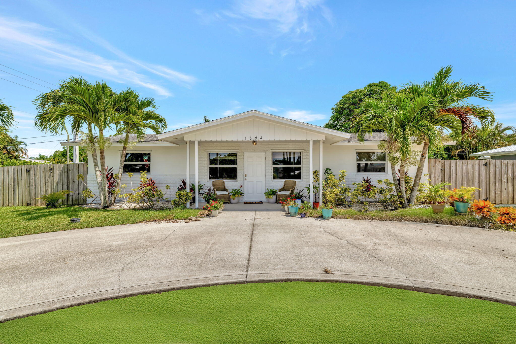 Discover the perfect blend of comfort, flexibility, and location in this beautifully updated Stuart home! Situated on a spacious fenced corner lot in the desirable Coral Gardens neighborhood, this versatile 3-bedroom, 2-bath residence offers much more than a traditional floor plan. Inside, you'll find an updated kitchen with stainless steel appliances, renovated bathrooms, tile flooring throughout, and multiple living spaces designed to fit today's lifestyle. In addition to the main living and dining areas, the home features a bright Florida room that serves as a second living area, media room, or entertaining space. An additional flex room provides endless possibilities as a home office, gym, hobby room, playroom, workshop, or extra storage.  The circular driveway offers ample parking and convenience, while the fully fenced yard provides privacy and room for pets, gardening, or outdoor gatherings. With no HOA restrictions, there's plenty of space for your boat, RV, trailer, or recreational vehicles. Ideally located just minutes from Downtown Stuart, pristine beaches, waterfront dining, shopping, parks, golf courses, marinas, and highly rated schools, this property offers the best of the Treasure Coast lifestyle. As an added benefit, the neighborhood is currently undergoing conversion to city sewer, a major infrastructure improvement expected to enhance long-term property value and modernization of the community. Don't miss this opportunity to own a move-in ready home in one of Stuart's most convenient and established neighborhoods.