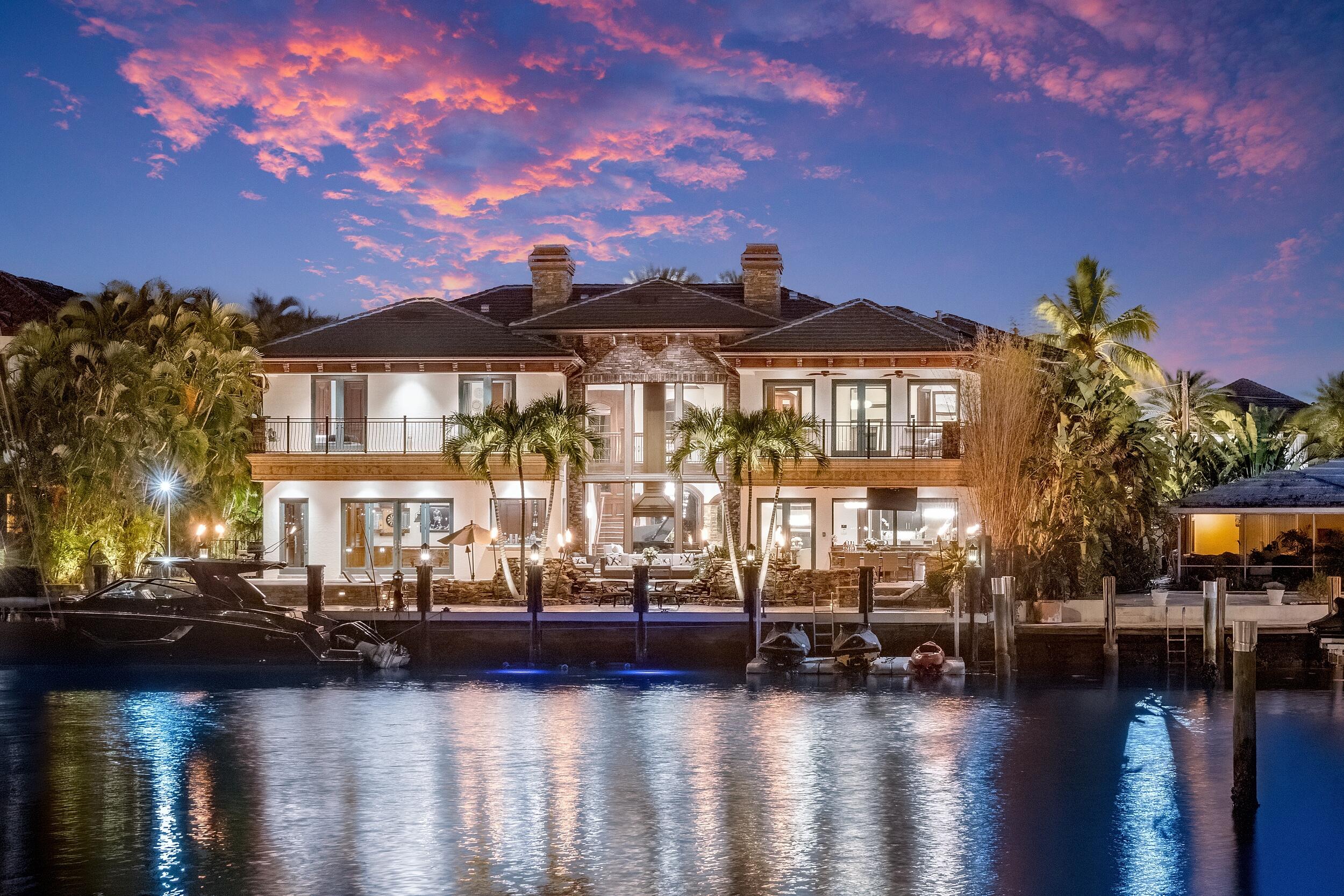 Introducing Villa Tremezzo, a privately gated West Coast Contemporary estate in Lighthouse Point's most prestigious enclave. Set behind lush landscaping and impressive stone walls, this extraordinary waterfront residence offers exceptional privacy, timeless architecture, and remarkable craftsmanship throughout.  A grand arrival leads into interiors defined by rare petrified wood stonework, rich custom millwork, and elegant Brazilian marble flooring. Designed for both luxury living and entertaining, the home features a chef's kitchen with Thermador gas appliances, six burners, Chicago brick ceiling accents, and a hidden butler's pantry. Smart home technology integrates lighting, sound, motorized shades, climate, and security throughout the residence. Resort-style outdoor living centers around a spectacular infinity edge pool with waterfalls, grotto seating beneath cascading water, spa, sun shelf, and color-changing lighting. The expansive outdoor space also features a summer kitchen, putting green, outdoor shower, fire torches, and beautifully illuminated tropical landscaping designed for unforgettable evenings.  The home offers an exceptional entertainment experience with a fully soundproof professional theater with 130-inch screen and high-end Sony projection system, along with a game room and bar.  Upstairs, a dramatic bridge hallway leads to a split-bedroom layout where each bedroom enjoys its own private terrace, walk-in closet, and en-suite bath. The luxurious primary suite features expansive terraces, spa-style bath with multi-jet shower, fireplace, custom bar, and boutique-style closets.  Additional highlights include an elevator, whole-house generator, four newer AC systems, copper gutters, whole-house water filtration and softening, central vacuum, advanced security cameras, and extensive smart-home automation.  Originally completed in 2014 and extensively upgraded, Villa Tremezzo is a rare custom-built showcase estate designed for the most discerning buyer.  The information published and provided including but not limited to prices, measurements, square footages, lot sizes, features, finishes, and calculations are subject to errors, omissions or changes without notice. All such information should be independently verified. All parties should perform their own due diligence to verify all information.