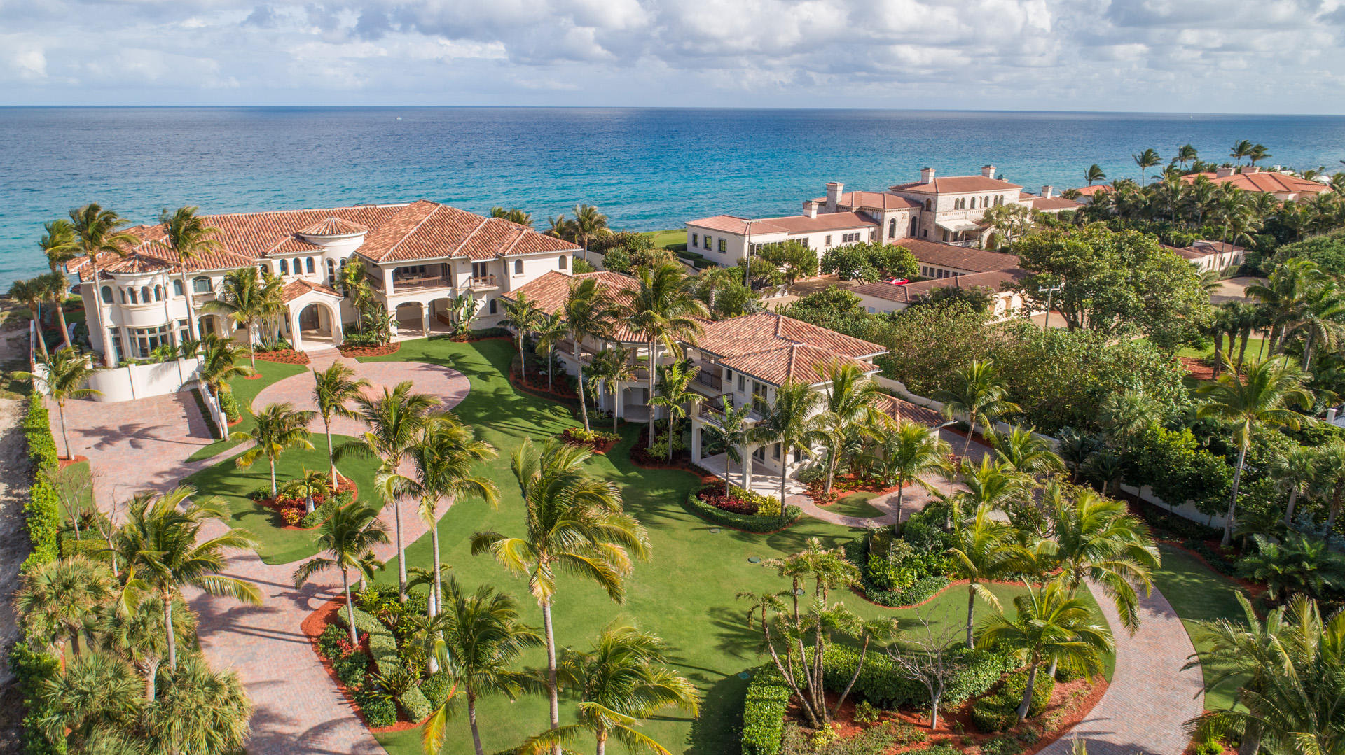 New Ocean-to-Intracoastal compound in the prized Estate Section is sublime and serene on 200± feet of beachfront and 200± feet on the waterway with dock. This seaside masterpiece brings the ideals of modern luxury to the classic Gold Coast tradition. Grand entertaining with a soaring great room,
multiple wet bars, club room, wine room, poolside ocean loggias. Sumptuous master wing, private guest house, 5 garage bays.The information herein is deemed reliable and subject to errors, omissions or changes without notice. The information has been derived from architectural plans or county records. Buyer should
verify all measurements Enchanting in an oceanfront dreamscape, this rare new compound offers the ultimate luxury in Manalapan's prestigious Estate Section between the Atlantic Ocean and Intracoastal Waterway.

Sublime and serene in the midst of the ocean's sights and sounds, this rare new compound spans 200± feet on the Atlantic Ocean, backed by another 200± feet fronting the wide Intracoastal Waterway, on the prized barrier island coastline of Manalapan's Estate Section, next to the landmark historic mansion built by Howard Stirling Vanderbilt, who chartered the town in 1931.
Bringing the ideals of modern luxury to the classic Gold Coast tradition, this seaside masterpiece on 2.14± acres was designed by Yates Rainho Architects, a Palm Beach-area firm with an award-winning global portfolio, and was just completed in 2018.

Lantern-lit gated entries give way to a long drive that winds along the sprawling front lawns to the stately six-bedroom main residence, while a second drive approaches the separate two-bedroom guest house.  Inside, fresh soft neutral tones refine the timeless living environment that discreetly integrates the advanced technologies and structural features.

By the spiraling staircase, the lofty foyer brings guests into the airy double-height great room, at once dramatic and understated, with a monumental wall of glass placing the attention on the inspiring ocean scene, and a statuesque fireplace as a focal point.  In this stunning space designed with entertaining in mind, cocktails can be served from the professional-style bar by the lounge area, opening out to the ocean loggia and pool by broad lawns that can expand the outdoor gathering space.

Accessed by either of the two elevators, the second floor features a sumptuous oceanfront master suite indulging in a fireside sitting area, romantic balcony, and two exquisite bath retreats.   Added luxuries of the estate include a five garage bays plus dockage for the boater in this exclusive Ocean-to-Intracoastal compound in one of South Florida's most prestigious communities, where residents also enjoy deeded privileges at the Five-Diamond Eau Palm Beach Resort & Spa and its La Coquille Club.

Location
South Ocean Boulevard, Manalapan, Florida.  Few places in the world rival the lifestyle of Manalapan, an idyllic oceanfront hamlet on the barrier island just south of Palm Beach. 

Property
An idyllic oceanfront paradise, this sprawling compound fronts 200± on the sugar-sand beach in an elevated site, protected by a massive seawall, and fronts another 200± feet on the Intracoastal Waterway equipped with a full-service ipe dock.  Sweeping lawns studded with palm trees present the main residence and guest house, and also stretch open from the breezy ocean loggias, served by a summer kitchen, next to the saltwater pool with flow-over spa.

Residence
At once classic and modern, this understatedly elegant residence provides a grand total of 23,795± feet  including the guest house  with eight bedrooms, twelve full baths, three powder rooms, walk-in closets, two elevators, three laundry rooms, and five garage bays.  There is exquisite millwork and impact glass throughout, and the floors are done in creamy Corsica marble and wide-plank walnut.  Leading-edge amenities include the full-house 150-kilowatt Kohler generator, Lutron LED lighting, electronically controlled window treatments, sophisticated security system, eight air conditioning systems, and four tankless water heaters.

First Floor:  Arched doors enter the two-story marble foyer and stunning window-walled oceanfront great room, anchored by a sleek fireplace across from the full-service bar.  Another fireplace highlights the oceanfront club room/library which also has a wet bar, as does the pre-wired theater room adjacent.  Looking out on the ocean and a garden fountain, the dining room flows off the oceanfront family/breakfast room where an island/bar separates the showpiece chef's kitchen outfitted with leathered and polished granite counters, a Dacor gas range with oven, two Dacor wall ovens, two Bosch dishwashers, and a Sub-Zero refrigerator/freezer.  There is an 1,100±-bottle connoisseur's wine room plus a butler's pantry, two powder rooms, and two full cabana baths.  Facing a private garden, the guest master suite features a bow-windowed sitting area, morning bar, and luxe bath.

Second Floor:  Open to the great room below, the oceanfront loft with wet bar and adjacent powder room has spiral stairs to the sensational rooftop observation deck.  Entered through a private vestibule with wet bar, the sumptuous master suite has a grand wing to itself.  Capturing spellbinding ocean views from inside and out on the private balcony, the walnut-floored bedroom is highlighted by a linear fireplace.  Exquisite stone finishes adorn the two master baths, one a salon-like retreat featuring a jetted tub, multi-head shower, and boutique-style wardrobe room.  The other bath also has a wardrobe room, and an exercise room is next to the master wing.  In the other wing, balconies open off the four bedroom suites and game room with bar.  Two of these bedrooms open to a glorious oceanfront balcony stepping down by the pool.

Guest House
Opening to loggias and balconies, this two-story residence has a living/dining room, kitchen, two bedrooms, and three baths.

DISCLAIMER: Information published or otherwise provided by the listing company and its representatives including but not limited to prices, measurements, square footages, lot sizes, calculations and statistics are deemed reliable but are not guaranteed and are subject to errors, omissions or changes without notice. All such information should be independently verified by any prospective purchaser or seller. Parties should perform their own due diligence to verify such information prior to a sale or listing. Listing company expressly disclaims any warranty or representation regarding such information. Prices published are either list price, sold price, and/or last asking price. The listing company participates in the Multiple Listing Service and IDX. The properties published as listed and sold are not necessarily exclusive to listing company and may be listed or have sold with other members of the Multiple Listing Service. Transactions where listing company represented both buyers and sellers are calculated as two sales. The listing company's marketplace is all of the following: Vero Beach, Town of Orchid, Indian River Shores, Town of Palm Beach, West Palm Beach, Manalapan Beach, Point Manalapan, Hypoluxo Island, Ocean Ridge, Gulf Stream, Delray Beach, Highland Beach, Boca Raton, East Deerfield Beach, Hillsboro Beach, Hillsboro Shores, East Pompano Beach, Lighthouse Point, Sea Ranch Lakes and Fort Lauderdale. Cooperating brokers are advised that in the event of a Buyer default, no commission will be paid to a cooperating Broker on the Deposits retained by the Seller. No commissions are paid to any cooperating broker until title passes or upon actual commencement of a lease. Some affiliations may not be applicable to certain geographic areas. If your property is currently listed with another broker, please disregard any solicitation for services. Copyright 2020 listing company All Rights Reserved.