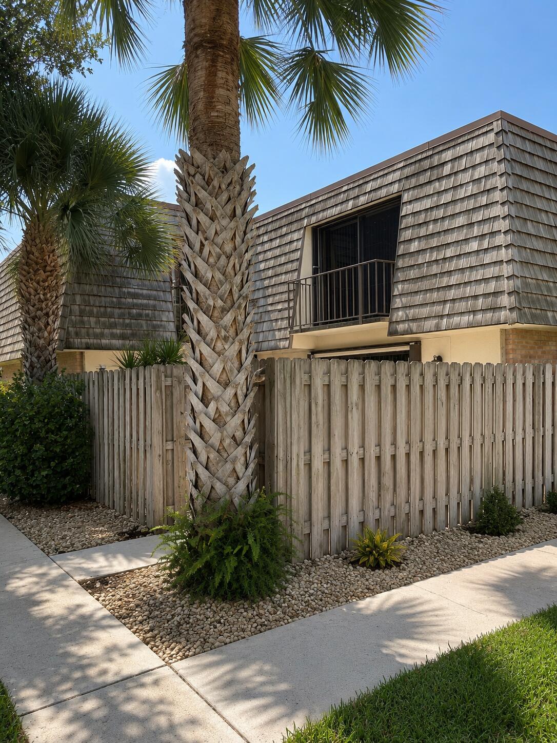 Welcome to this beautifully updated two-bedroom, two-bathroom townhouse nestled in the desirable Lakewood of Palm Springs community! This investor-friendly community allows rentals immediately, making it an excellent opportunity for both homeowners and investors. Move-in ready and featuring brand-new flooring, fresh interior paint, and priced to sell, this home offers the perfect blend of comfort and style. The well-appointed kitchen is ideal for cooking and entertaining, showcasing stainless steel appliances, granite countertops, a breakfast bar, wood cabinetry with recessed lighting, and an open layout that flows seamlessly into the spacious living area. Each bedroom features its own private balcony, while the kitchen opens to a private fenced patio—perfect for relaxing or entertaining. Located in a peaceful, quiet community with convenient access to shopping, dining, major roadways, and public transportation, this exceptional property combines comfort, convenience, and immediate income potential. Whether you're looking for your next home or a great investment, this one is a must-see!