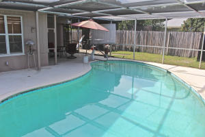 Have you been looking for a great value on a home that you can make your own? You will love this 4 bedroom home on a 1/4 acre lot. There are a lot of upgrades started for you including a large pool, granite countertops, tile floors, a newer roof, and an updated electric panel. Inside there are gorgeous, vaulted, beamed ceilings that make the living space inviting and open. The kitchen was updated only 2 years ago making this the ideal place for someone who loves to cook. This is the ideal layout with a three way split floor plan. The 4th bedroom also has great storage space. Outside The owner has installed a chain link fence with a 10' wide gate for boat storage, as well as a large circular driveway. There is great privacy with mature eureka palms out front.