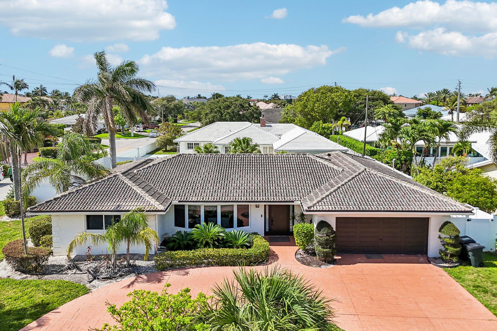 Welcome to Venetian Isles, one of Lighthouse Point's most sought-after neighborhoods! This stunning 3-bedroom, 2.5-bath home sits on an oversized corner lot with beautifully updated living space throughout. Enjoy an open floor plan with gleaming porcelain floors, a cozy fireplace, renovated chef's kitchen, and updated bathrooms. Impact windows and doors throughout for ultimate peace of mind. Step outside to your private pool, spa, and patio — perfect for entertaining. Walking distance to the Yacht Club and truly move-in ready — don't miss this one!