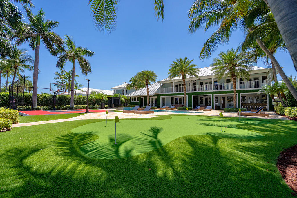 Rare opportunity to own nearly 20,000 SF of direct Intracoastal property near the Hillsboro Inlet with 100' yacht dock in a no-wake zone. This completely remodeled Key West-style estate offers a relaxed luxury lifestyle with a covered terrace, outdoor kitchen, basketball half court, putting green, sauna, cold plunges, and huge pool/spa overlooking the blue Intracoastal waters. Thoughtfully designed floor plan features a downstairs primary suite with dual baths, plus 2 additional beds/baths and laundry room on the main level. Stunning designer kitchen with backlit onyx and top-tier appliances. Upstairs offers 3 more bedrooms, 2 baths, loft, wet bar with full-size refrigerator/microwave, laundry room, and expansive balcony with panoramic views of the estate and Intracoastal waterway.