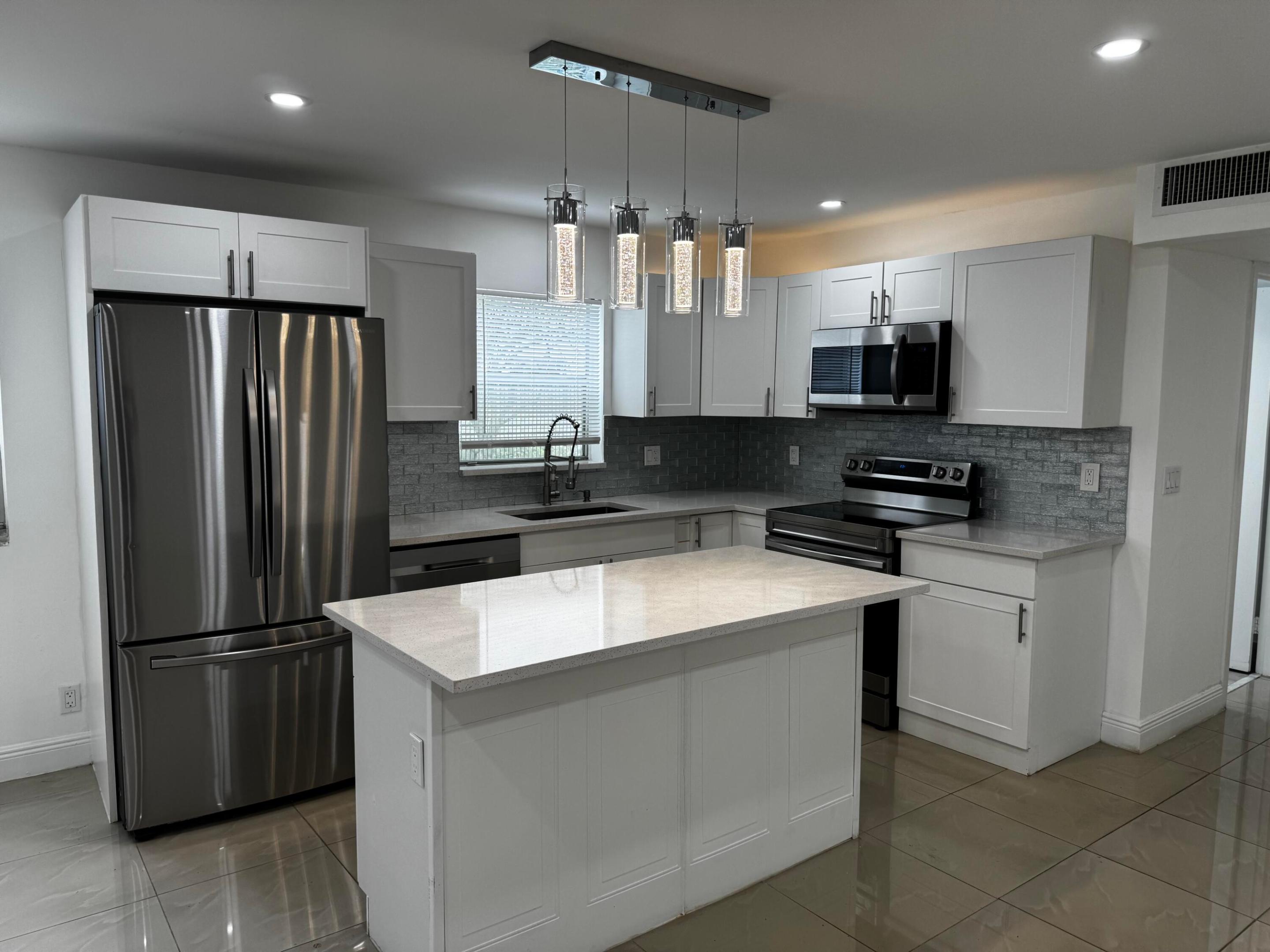 ** BEAUTIFULLY RENOVATED 2 Bed/2 Bath FIRST FLOOR CORNER UNIT in the 55+ community of Kings Point. Spacious living room with open-concept kitchen.  NEW AC 2025! Full size Washer & Dryer. Gated security. Close to the Monaco pool & clubhouse. Enjoy resort style living with amenities that include 2-18 hole golf courses, fitness center, tennis, pickleball, indoor & outdoor pools, theater with live shows, cafe, and free shuttle bus services to shopping & dining! ** Must be 55+ or older. ** No Pets.