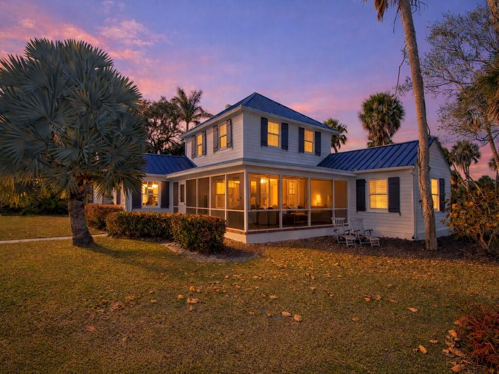 Welcome to St. Lucie Village. This historic home sits on a half of an acre with wide Indian River Lagoon views from every room in the house. Enjoy the sun rising over the river every morning on your screened patio or in the additional den just off the main living area. With 3 bedrooms plus a den/studio or painting room and 2 full bathrooms this home feels much larger than 2,004 square feet. 1.5'' standing seam metal roof installed in 2024 with new straps and blown in insulation. New water softener with R.O. water in the kitchen. The interior of the home has been thoughtfully updated with crown molding throughout, re surfaced original wood floors, custom built-ins that complement the architecture of this historic home perfectly.