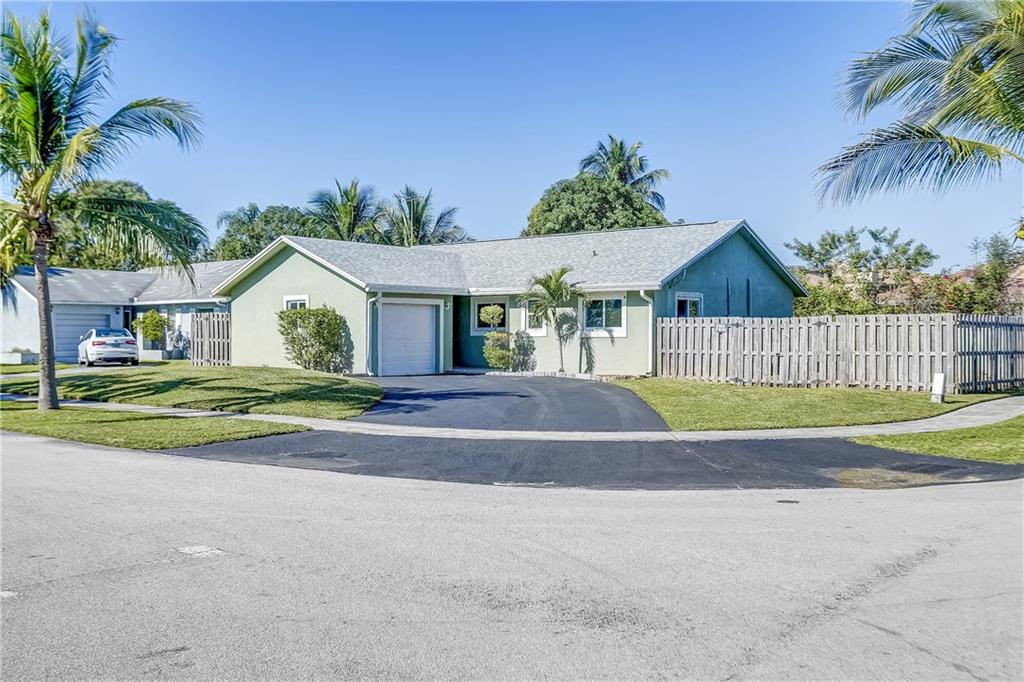 This perfect starter home or investment opportunity is located on a huge lot completely fenced and offers a spacious layout in a very quiet, welcoming neighborhood.  Double-pane patio doors opens onto  yard with fruit tree, very private, great for entertainment. Back yard has room for a pool. The home is freshly painted in neutral tones.  The living & dining room has an open floor plan w/vaulted ceilings & windows for a bright interior.  The car garage is converted into a room with built-in closet, can be reconverted. The windows and sliding glass door in the master bedroom are hurricane impact. The roof was installed in 2020. The home is close to place of worship, shopping and major highways, elementary, middle and high school.