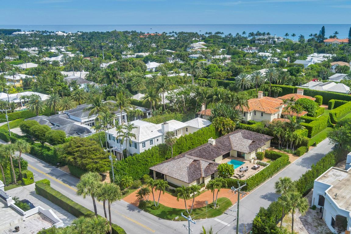 Located on North Lake Way and South Woods Road, this North End property sits on a generous 11,761± square-foot corner lot.
The residence offers 3,826± total square feet with 3 bedrooms, 4 and a half bathrooms, a large pool and 2-car garage.  The home's layout is designed around the south facing pool allowing for an abundance of natural light throughout.  The living room has vaulted ceilings and a modern fireplace with sliding glass doors out to the pool terrace.  The dining room has a wet bar, easy access to the kitchen, as well as doors to the pool.  The eat-in kitchen features an island, ample storage, and a built-in desk.
The primary bedroom is located on the east side of the house for added privacy and features doors to the pool, a walk-in closet, and an ensuite bath with a separate tub and shower. The guest bedrooms are located on the west side of the home and have ensuite baths.
Additional features include two driveways and a full-house generator. Ideally located in close proximity to the Lake Trail, the beach, and in-town shopping and dining.
