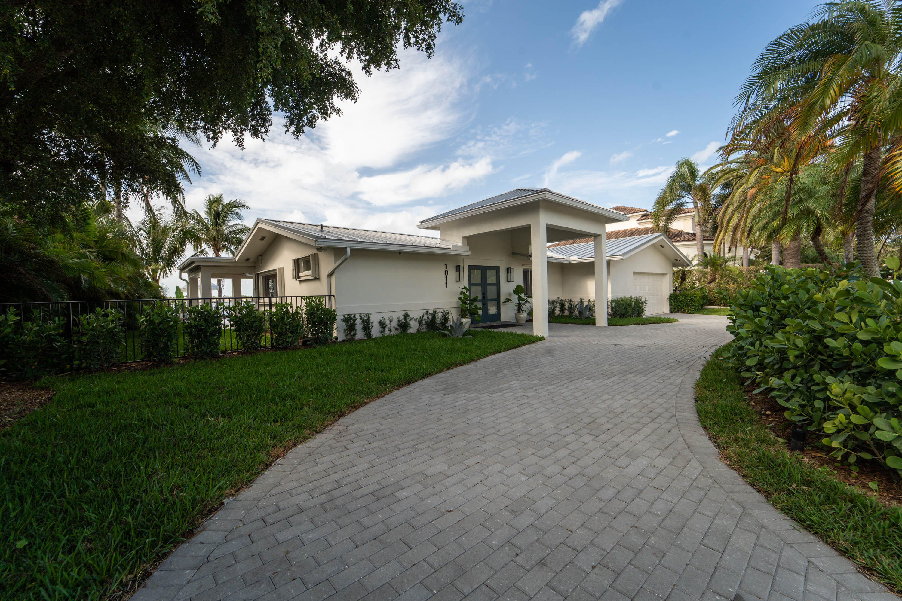 Bring your boat- just minutes from the Sailfish Club! This meticulously designed home features expansive water views and a gorgeous private dock just minutes from the Palm Beach Inlet and deep water fishing. Large lot with room to expand. This practically new construction home boasts a new metal roof, a whole house generator, an $10,000 whole house water filtration system, all new bathrooms with high-end fixtures, as well as new flooring, millwork, light fixtures, and custom cabinetry throughout, recently replaced dock and seawall, all new AC units, and a new tankless water heater. The kitchen is a chef's delight, equipped with a gas range & a spacious butler's pantry. The large private yard is perfect for entertaining, featuring a gas firepit... Enjoy unobstructed sunset views from your backyard while soaking in the refreshing ocean breeze. Easy walk or bike ride to gorgeous beaches along the Atlantic Ocean. There is ample room for a large addition, allowing you to customize your dream home further. Close to restaurants, shopping, and Palm Beach International Airport. This is a rare opportunity to own a slice of paradise in a prime location. Don't miss your chance to embrace an incredible waterfront lifestyle!