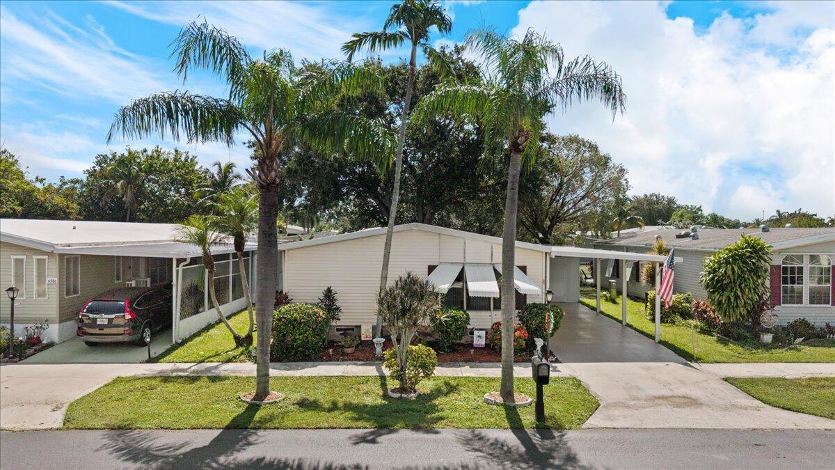 Welcome to this charming 2-bedroom, 2-bathroom manufactured home nestled in Tallowwood, Coconut Creek, offering 1,696 square feet of comfortable living space. This home offers a spacious floorplan overlooking a canal,  snack bar in kitchen, and lovely master suite. Air conditioner appx. 1.5  years old, water heater 5 years. Well maintained home in this adult, gated community. Sold as-is with the right to inspect.