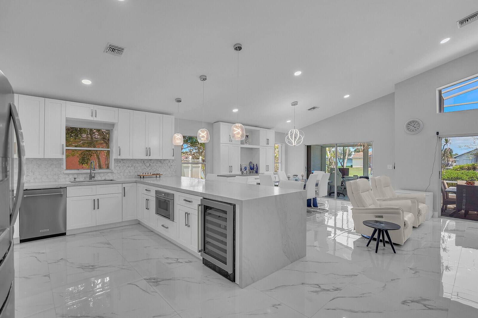 NICEST HOME IN THE COMMUNITY! This beautifully renovated single-family home is in the highly desirable gated community of Newport Cove! This move-in-ready residence features soaring vaulted ceilings, a bright and open floor plan, and stylish modern finishes throughout.  The large dream kitchen is sure to impress with elegant quartz countertops, premium stainless steel KitchenAid appliances, and ample space for cooking and entertaining. Luxurious bathrooms have been completely remodeled with designer tile, frameless glass showers, LED mirrors, and contemporary fixtures. Rectified porcelain tile flooring extends throughout the home, creating a seamless, sophisticated look, while fresh interior paint adds the finishing touch.  Work from the enclosed bonus room overlooking the lake, conveniently located just off the dining area, or unwind on the tranquil screened-in patio while taking in the peaceful water views. Newport Cove offers outstanding amenities, including a beautiful clubhouse, resort-style pool, tennis courts, and a fitness center. Ideally located near beaches, shopping, dining, and medical facilities, this exceptional home combines luxury, comfort, and convenience.
