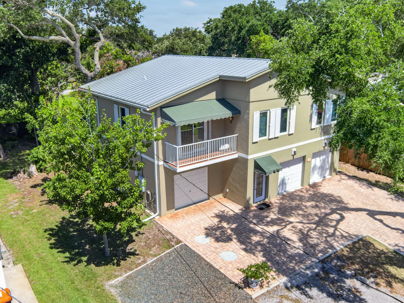 Meticulously cared for Hurricane Resistant build with 3 car garage, Poured Concrete Walls, with concrete poured onsite with reinforced concrete, built in 2015, standing seam metal roof, hurricane impact windows!  Mango & Avocado trees, plenty of storage, upstairs is a 2 bedroom, 2 bath home with bamboo floors and lovely back porch!  Enjoy the large backyard with  hot tub, outside shower and plenty of room for a pool. Two blocks to the beach or bike the Jungle trail!  NO HOA, so bring your RV or boat!   Perfect for year round or an investor that wants to Airbnb. Room sizes are approx sizes