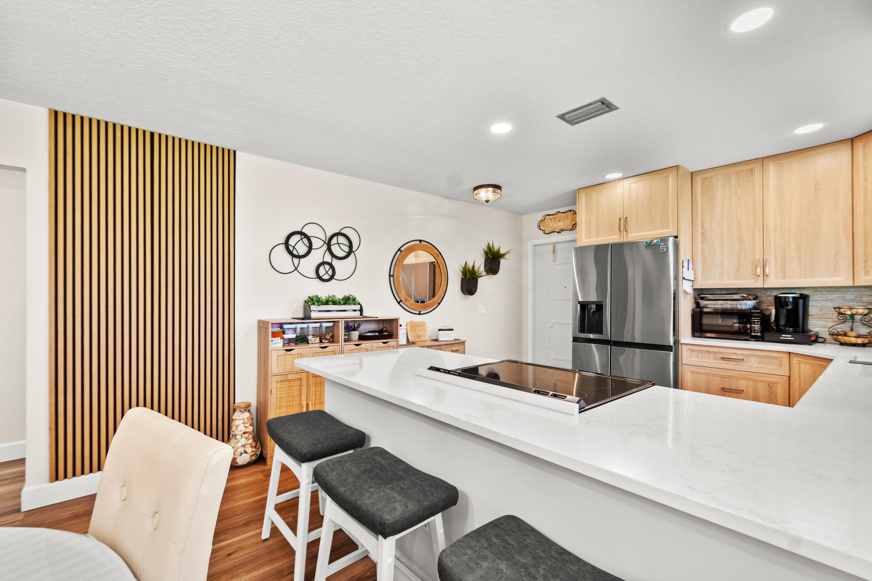 Discover relaxed coastal living in this beautifully renovated 2-bed, 2-bath Plan B corner unit. Featuring new luxury vinyl plank flooring throughout, a fully updated kitchen, and renovated baths, and inside washer and dryer, this residence is move-in ready and designed for comfort and style. The desirable corner-unit layout offers added privacy and natural light. Centrally located in the community, the residents enjoy an array of amenities perfect for relaxing. An added opperunity — the neighboring unit is also available, offering a rare opportunity for expanded living or investment potential.