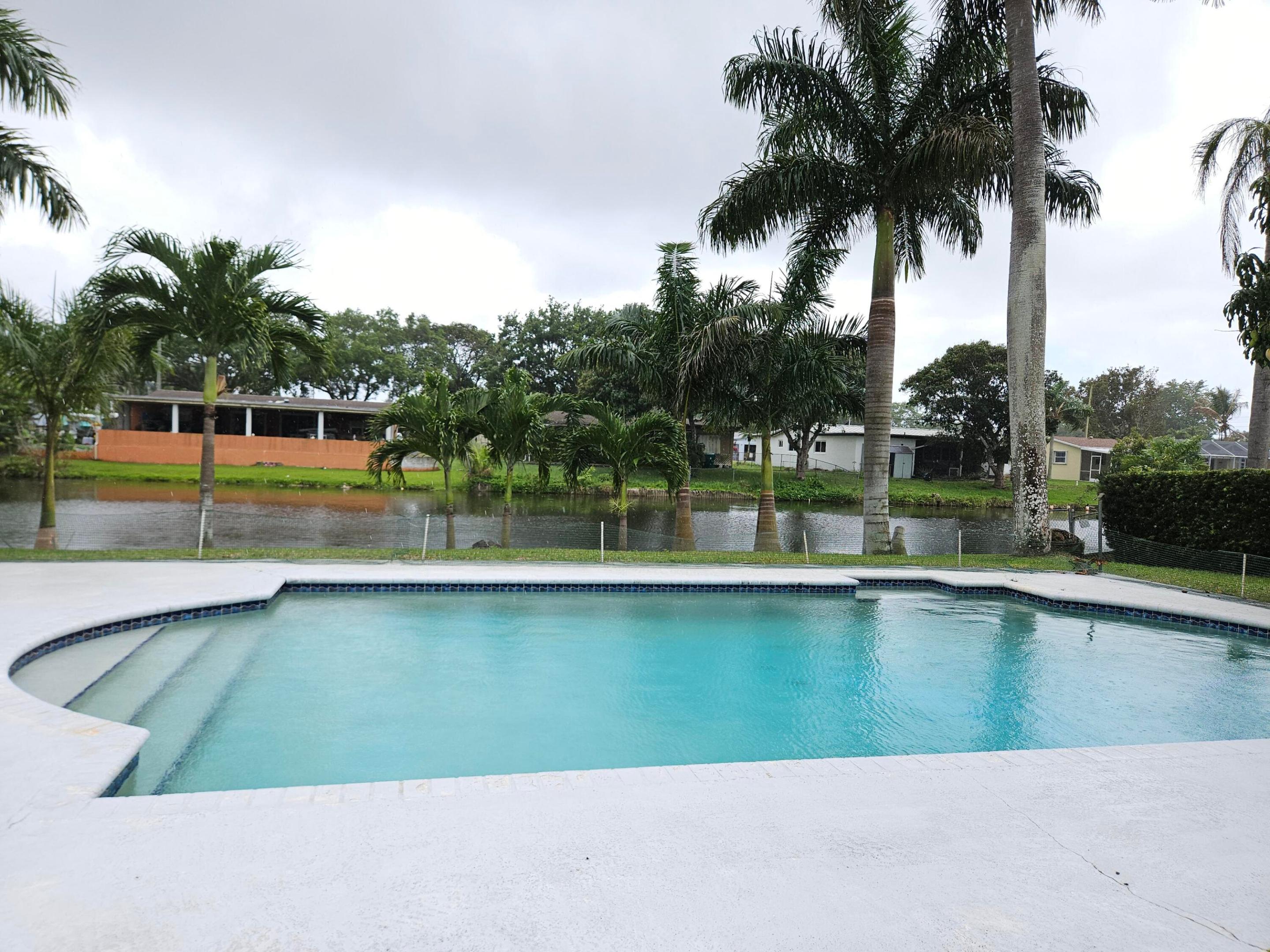 Lovely waterfront Cooper City pool home with a screened in carport.  Close to 1/4 acre lot.  No HOA.   Laundry room off kitchen area. Roof 7 years old.  Central air with 2 extra mini splits in each bedroom .  Large screened in porch in the back overlooking  the pool and canal. Plenty of space for entertaining.   Good schools zone.  Lots of potential.  Don't miss this opportunity