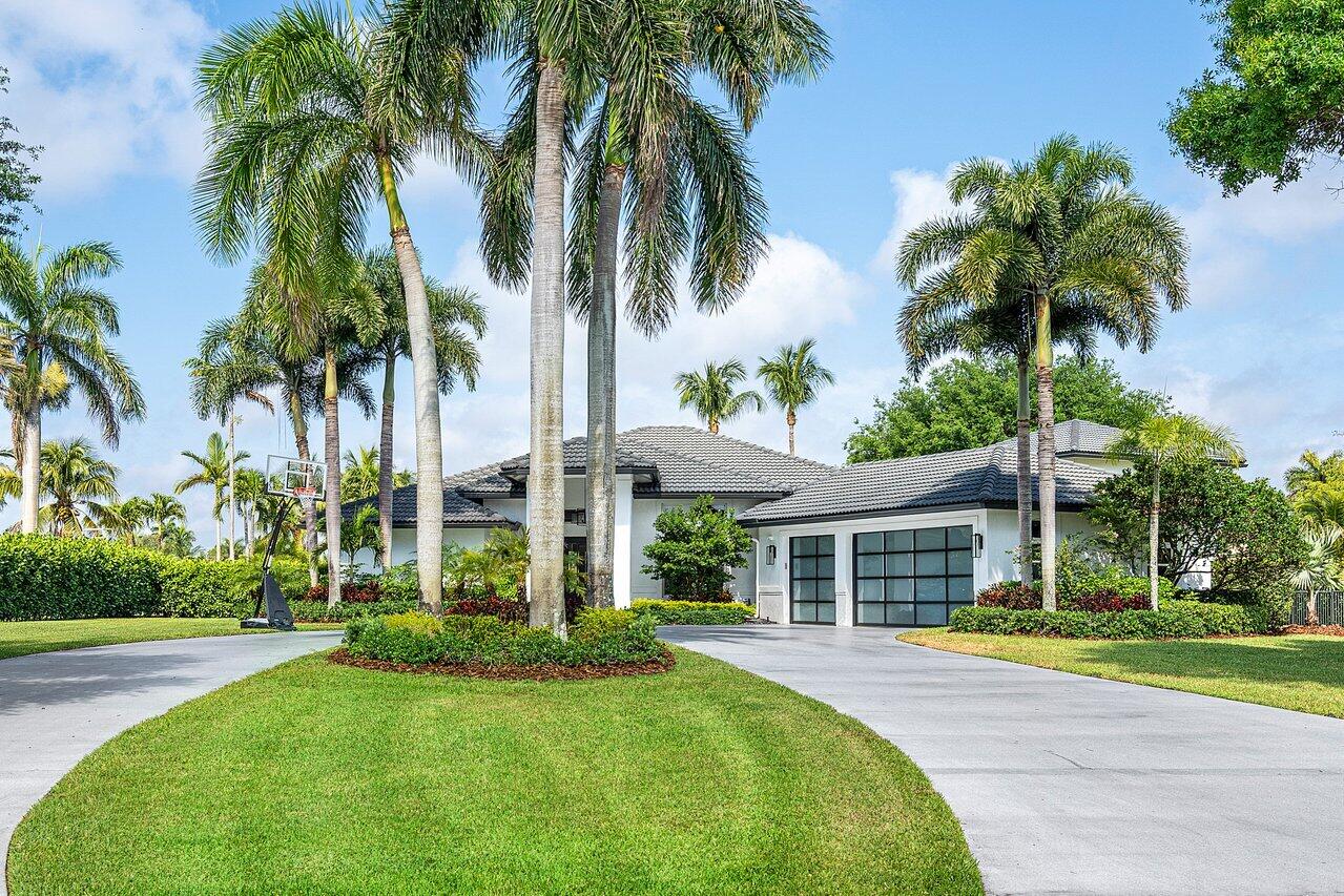 EXCEPTIONAL property in Delray Beach. No expense spared at this ACRE LAKE FRONT tropical RESORT STYLE ESTATE being sold fully furnished. The space is maximized for entertaining and designed with the finest luxury finishes, fixtures and custom furnishings. It is 4/5 bedroom Plus an office. The 5th bed can also be used as a family room/game room with a loft area above (with shuffle board). The loft is the only sq ft on 2nd level. Huge primary walk in closet with island. The home has gorgeous ceiling details, Wolf and Sub zero appliances, Sonos surround sound system cat 6 wire, remote control blinds, 10 tvs, and a 800 gallon Kohler emergency backup generator which can run the entire home for 2 weeks.  The oversized 3 car air conditioned garage has glass impact garage doors. Make this your home gym! Huge fenced yard with a new 32x16 pool and jacuzzi.  The pool has a heater AND chiller with salt water system and a heated outside shower. The 3 Fireballs beside the pool light up for a dramatic effect at night. The entertaining continues in the backyard with the pergola, Hibachi grill, outdoor bar, fridge and an in ground trampoline, a ping pong table, a foosball table AND the lake is stocked with peacock bass! All the outdoor lighting which lights up the palms, driveway, driveway island, house and cove lights are spectacular. The sonos system, cameras, alarm, garage, pool, and jazucci can all be controlled via the wifi on phone.  Newly redone paver driveway. Main roof 1 year old, AC's 8 months and 1 year.  This is a manned gated community with all large lots and new construction homes listed from 7.8-15.8 million. A rated schools. All measurements are approximate.