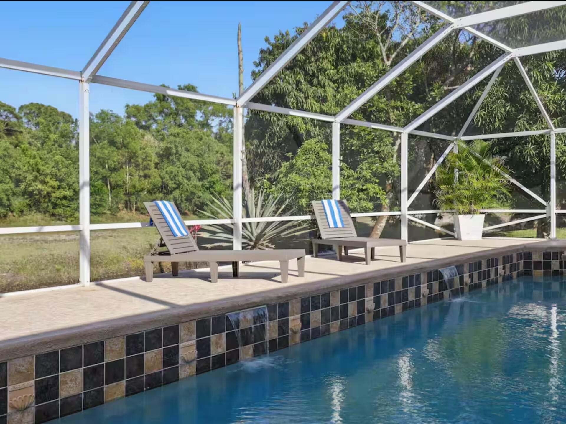 Stunning 4-bedroom, 2-bath CBS pool home. Heated saltwater pool with screen enclosure, 2-car garage, and spacious covered patio.