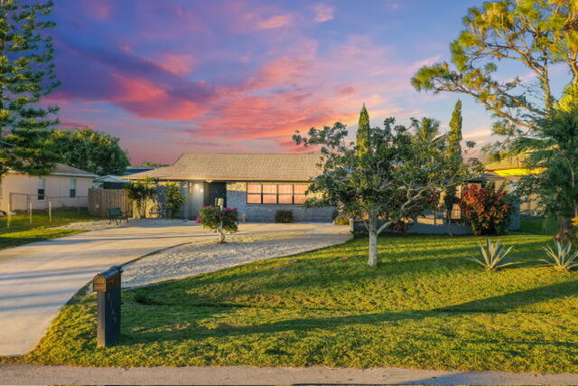 New Roof being put on for New Buyer! Beautifully maintained 3-bedroom, 2-home located in the desirable Sandpiper Bay community, just minutes from the beaches, golf, dining, and shopping. This property offers a gourmet kitchen with modern cabinetry, sleek countertops, stainless steel appliances, and a spacious island overlooking the main living areas. The open floor plan provides excellent natural light and a seamless flow throughout the home. Enjoy added privacy with the split-bedroom layout, with the primary suite offering an ensuite bathroom. A standout feature is the enclosed Florida room, ideal for additional seating, office space, or relaxation.