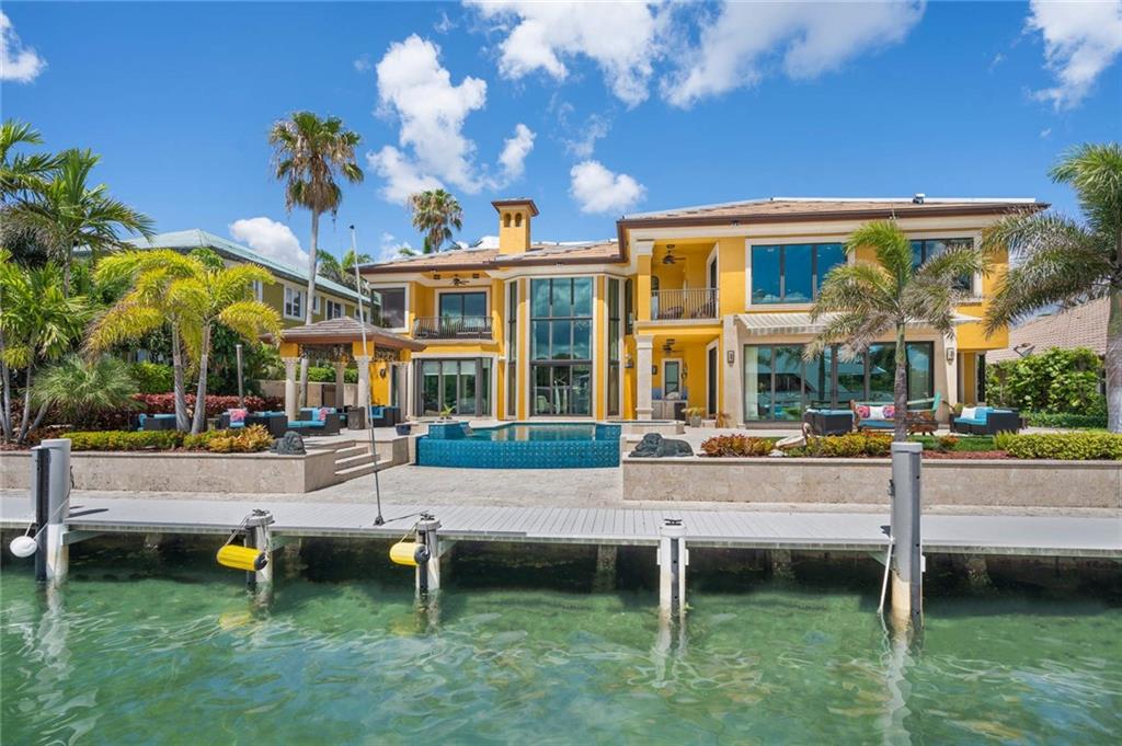 Live your luxury lifestyle in this beautiful east-facing Lighthouse Point Intracoastal home. Enjoy amazing views of the Intracoastal Waterway and iconic Hillsboro Lighthouse from almost every room. The gated residence was custom built in 2001 and features 4 bedrooms plus an office, 6 bathrooms, loft, elevator, wet bar, custom cabinetry and closet systems, whole-house generator and so much more. Enjoy an Infinity-edge pool and spa, 100’ of water frontage and a T dock with water and electricity that can accommodate multiple vessels.
