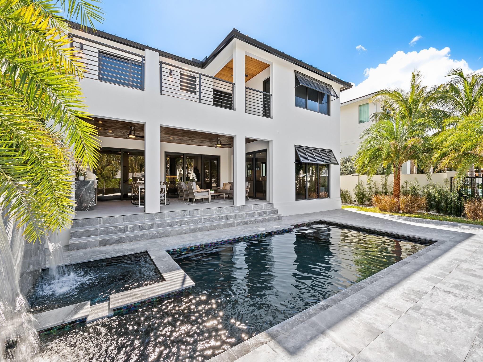 Stunning New Construction Modern Masterpiece in Rio Vista! 5 bed/5.5 bath gated residence boasts 65’ prime waterfront, private elevator & lux amenities. Chef's dream kitchen w/Viking 6 burner gas stove/griddle, Bosch integrated coffee maker, Viking double door refrigerator/freezer, 2 Viking dishwashers, European cabinetry, 24" Thermador wine column & ice maker. An impressive layout of this well-designed home along w/smart technology, electronic shades, electric remote touch fireplace. Baths adorned w/exquisite glass tile/stonework, principal bath has dual vanities, soaking tub & programmable hot steam shower! Expansive covered summer kitchen w/gas grill, refrigeration, electric phantom screens. Heated salt pool/spa surrounded by beautiful marble decking. New composite dock/raised seawall!!