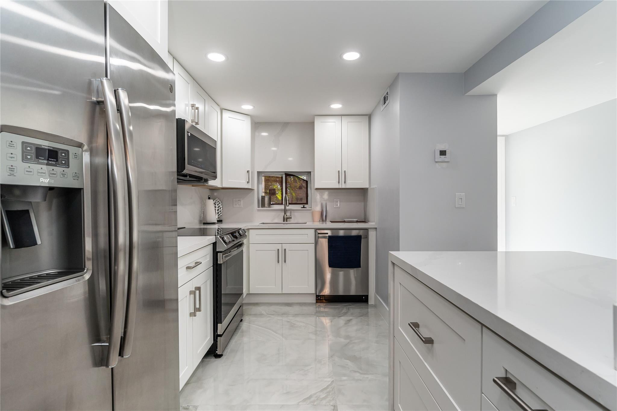 ABSOLUTELY THE MOST BEAUTIFUL, NEWLY & TOTALLY RENOVATED 2BR/2BA apartment in Hollybrook. ALL NEW AMENITIES INCLUDE: Wide Open Kitchen featuring SS Appliances, Quartz Countertops, Raised Ceiling, Bright LED Lighting & more. Washer/Dryer inside. Large ceramic tile throughout. Impact Windows. Recreation Lease PAID IN FULL.  Convenient 1st floor steps from pool/BBQ. Amenities include Restaurant, Billiard Room, Bbq/Picnic Area, Clubhouse, Courtesy Bus, Exercise Room, Heated Pool, Library, Putting Green, Sauna, Shuffleboard, Tennis, Pickle Ball, Vehicle Wash Area, Electric Car Charging Station. Close to shopping, dining & highways. 15 min. to the beach. ABSOLUTELY THE VERY BEST!