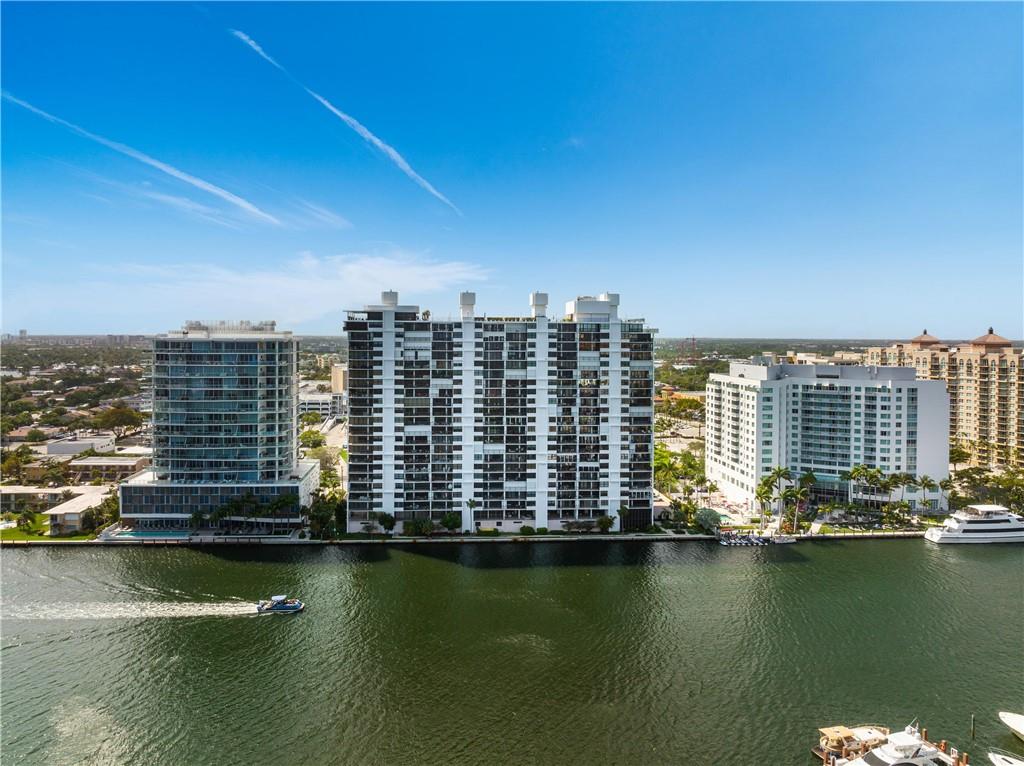 TRIPLE WOW! Directly on Intracoastal with a direct view of the Bonnet House & ocean. Fully & elegantly upgraded with emphasis to minute details, a perfect fusion of classic elegance & contemporary vision: Remodeled enclosed kitchen with granite countertops, rich wood cabinets, breakfast nook,  eat-in kitchen with a trash chute. Porcelain tile in kitchen & baths & rich walnut engineered wood flooring throughout. Semi-private elevator. Hurricane-impact windows & sliding doors with custom-designed California shutters in bedrooms & electric roller shades in living room.  Smooth ceilings, recessed lighting, walk-in closet + wall closets, front loader stack W/D, extra storage room, SINGLE GARAGE parking (not tandem). Next to Galleria mall and 2blks to the beach. 24hr security guards & more.
