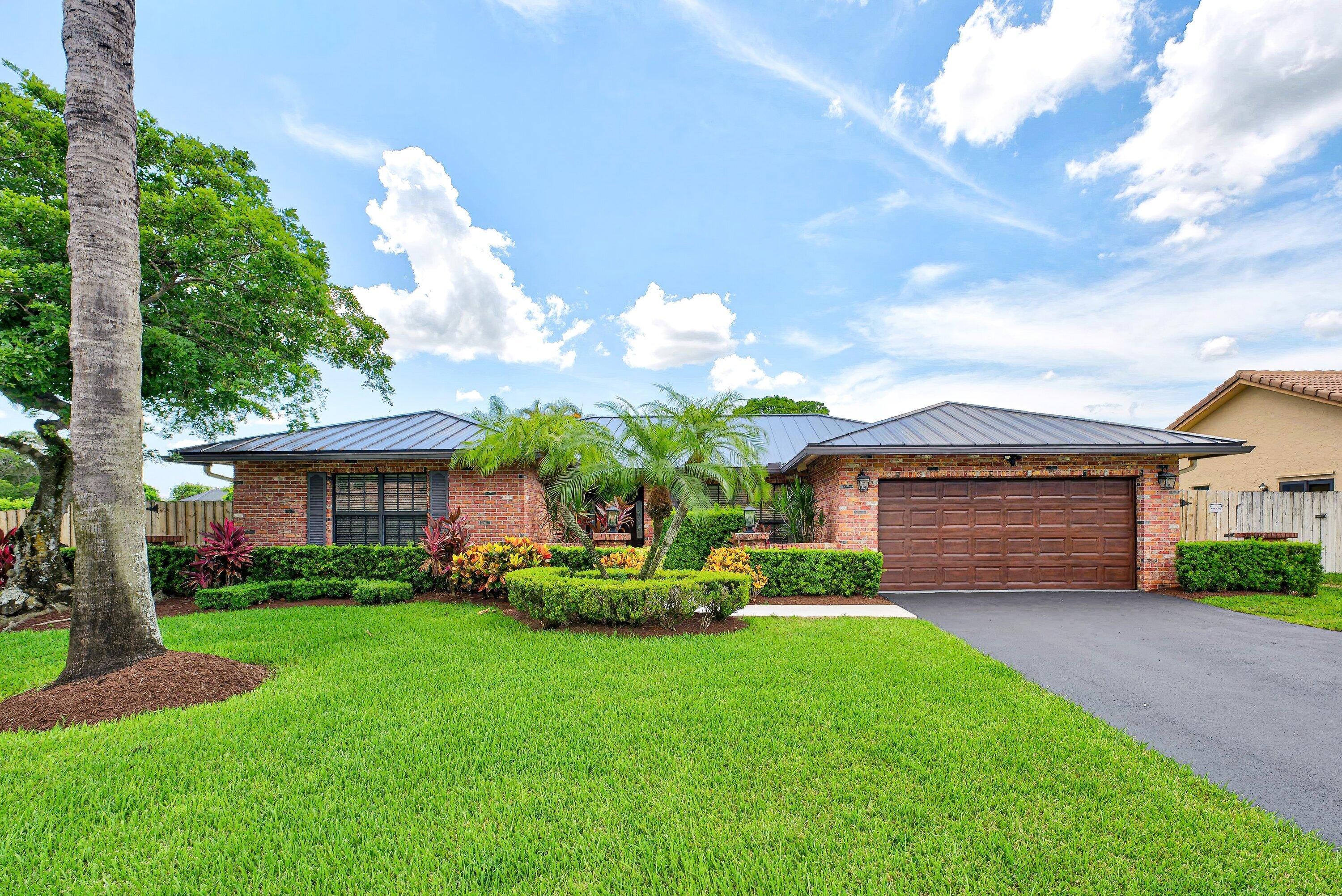 Spacious and pristine 4-bedroom, 2-bath pool home in the highly sought-after Logger's Run community of West Boca, zoned for top-rated schools! Move-in ready with 20x20 tile flooring throughout, a custom kitchen, freshly painted interior, 2025 roof, impact windows and sliders, updated fixtures, ceiling fans, and abundant natural light. The primary suite features a walk-in closet and cabana bath with direct pool access. Enjoy Florida living in the fully fenced backyard with beautifully maintained grounds, a sparkling pool, and a large covered patio. Additional upgrades include epoxy flooring in the 2-car garage, Tesla charger, new electrical panel, repaved driveway, and 2025 WH. Minutes to South County Regional Park with golf, tennis, water park, nature center, fishing, boating, and more.