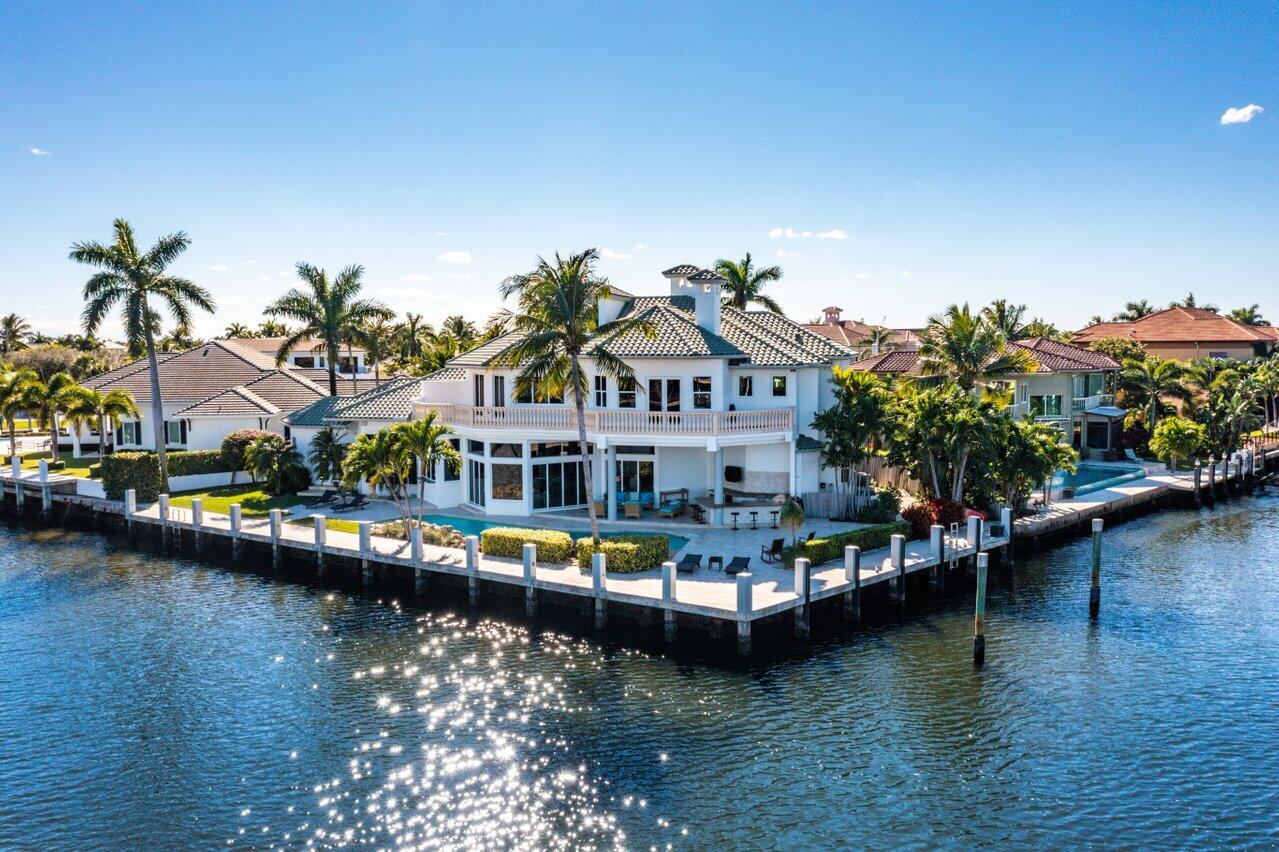 This exceptional and stunning reimagined point lot estate home is located on the direct Intracoastal and is beyond impressive.  It encompasses 200 ft of waterfront and has dramatic breathtaking water views from everywhere.  The dock is totally redone with concrete pilings, new cap, electric, etc. and is ready for the avid yacht enthusiast!  This residence features 6 bedrooms (all ensuites), 6 full baths, 2 .5 baths, plus loft/play area on 3rd floor.  The separate Living Room with high volume ceilings as you enter the home captures extensive water views.  The gourmet custom kitchen is appointed with Viking, Thermador, Miele & Bosch appliances.  It is completely open to the generous family room, bar area and eat-in area with endless water views.  There are 2 bedrooms downstairs and (MORE) 4 upstairs, all ensuites and the Master upstairs has a closet that is incredible!  The outside entertainment area includes an oversized heated pool & spa, large summer kitchen, extensive patio for al fresco dining and entertainment.  This 6,000 sf of living estate boasts multiple balconies to sit and enjoy the east breezes.  You are only a mile stroll to the beach and short distance to Atlantic Ave with fine dining and shopping.