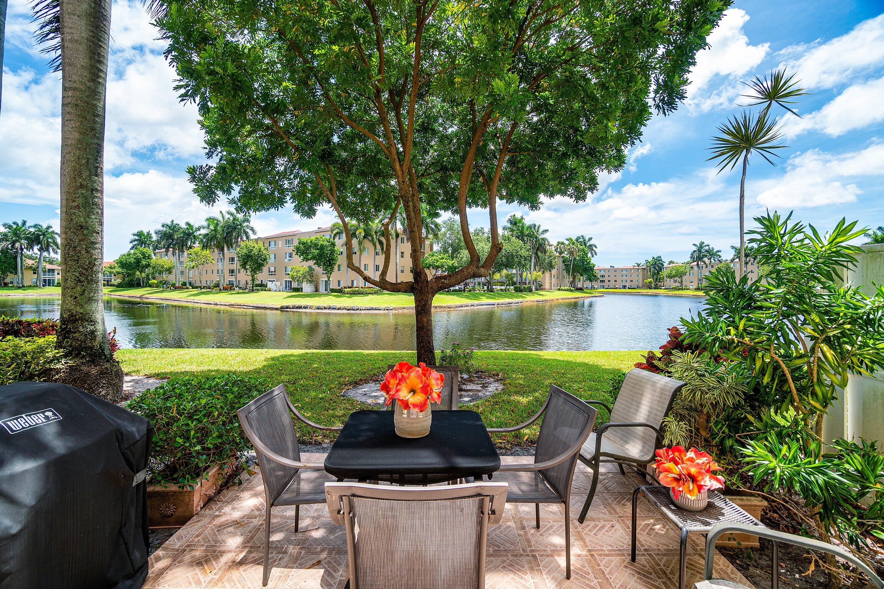 YOUR OWN PRIVATE WALKWAY w/GARDEN (no catwalk here!) ENTER THE COVERED SCREENED PORCH TO THIS GORGEOUS GROUND FLOOR TRUE 3 BED CONDO!  EXTREMELY LIGHT & BRIGHT w/ PANORAMIC LAKE VIEWS & YOUR OWN OUTDOOR PATIO TO STEP OUT & GRILL w/ FRIENDS!  ROOF 2024 (no special assessment!) NEW A/C. A STUNNING NEW CHEF'S KITCHEN FEATURING QUARTZ COUNTERTOPS w/ ROOM FOR 4 BARSTOOLS, TONS OF CABINETS & LARGE PANTRY (w/ pull out drawers!)  HUGE PRIMARY BEDROOM w/ MASSIVE SITTING AREA. GREAT STORAGE & CLOSET SPACE! LARGE LAUNDRY ROOM w/ LAUNDRY SINK. CORAL LAKES FEATURES AN AWARD WINNING RESORT STYLE CLUBHOUSE w/ RESTAURANT, 600 SEAT THEATER FOR SHOWS & ENTERTAINMENT, FITNESS CENTER w/ CLASSES, ART STUDIO, PICKLEBALL & TENNIS, MANY RESORT POOLS & INDOOR POOL, MANY CLUBS & CARD GAMES TO JOIN!