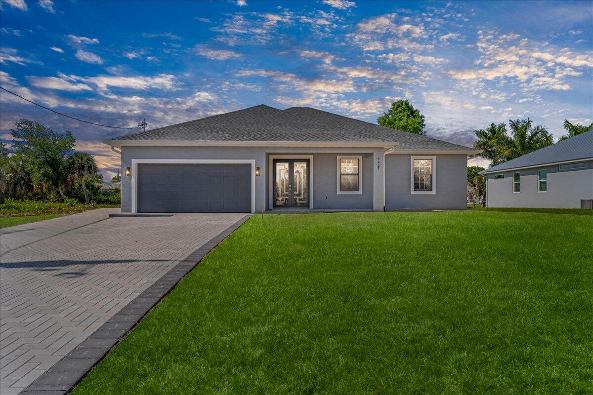 Welcome to this brand new 2026 built home in Port Charlotte, perfectly positioned on a canal with peaceful water views and added privacy. This 4 bedroom, 3 bath + office/den residence offers 2,283 sq ft of living space and over 3,100 total sq ft, featuring an open-concept layout with vaulted ceilings, abundant natural light, and modern finishes throughout. The kitchen flows seamlessly into the living and dining areas, ideal for entertaining. Enjoy impact windows and spacious 2-car garage, and covered outdoor space perfect for relaxing or hosting. The primary suite offers a private retreat, while additional bedrooms provide flexibility for guests or family. Rare new construction move-in ready and priced to sell.