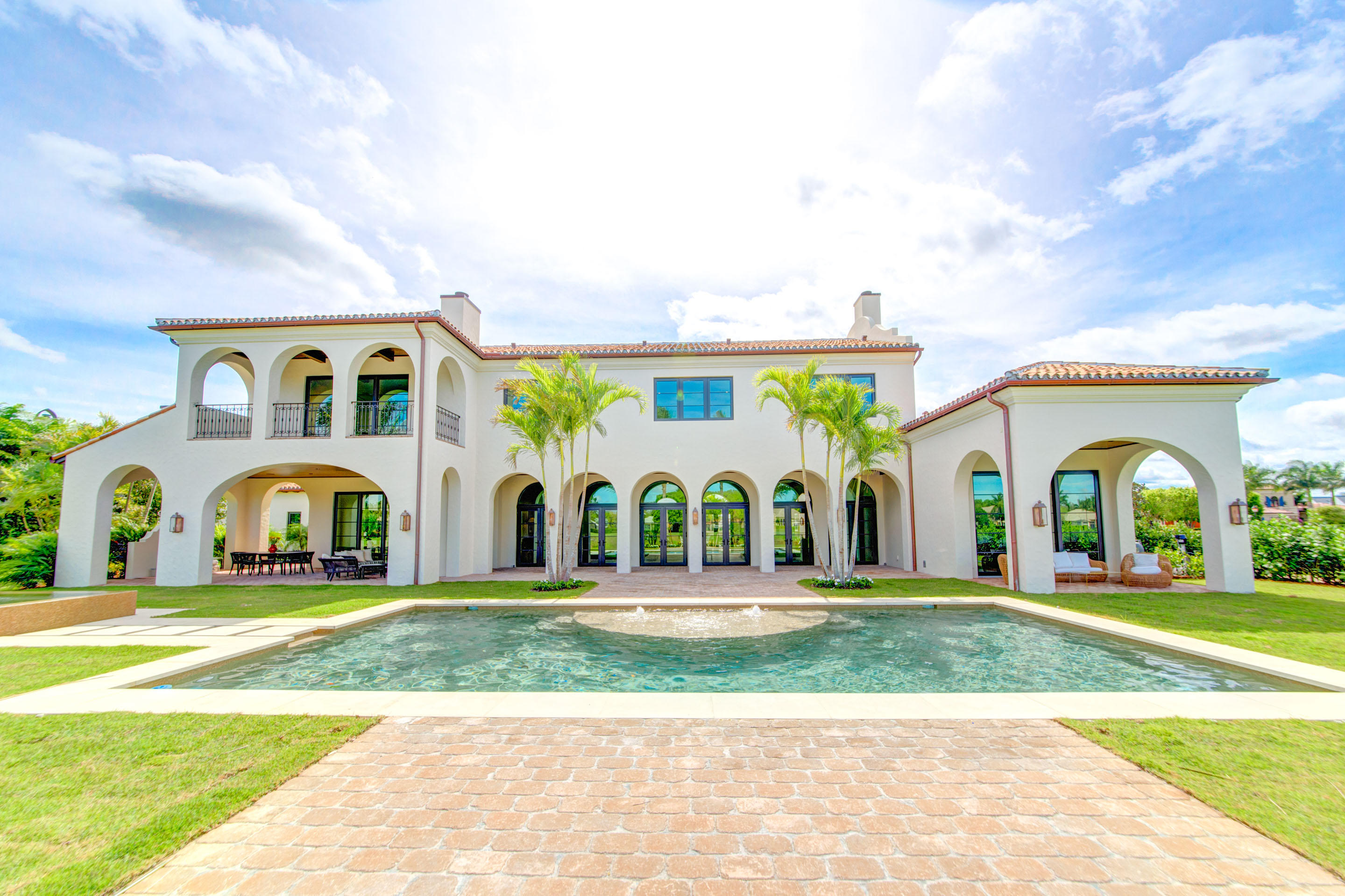 Best value on the street as far as lot size & price/square foot. Enter this true estate home through elegant arched doorways off the private courtyard. The entire home is positioned to enjoy the optimum natural light. Open floor plan, perfect for entertaining, leads to the chef's kitchen, the utmost balance of beauty and functionality, with contrasting cabinetry, Subzero & Wolf appliances, and stylish craftsmanship with a custom copper hood and large wine room. With no detail left untouched, from the Cypress tongue and groove ceiling to the tumbled pavers, the entire property is truly resort quality. Living areas open onto the immaculate back yard, complete with oversized pool and spa, water features, outdoor dining area, and wood-burning fireplace. The floor plan lends itself to hosting out of town guests, with bedrooms split between the first and second floor, all finished with oak flooring, morning bar, and dual-story laundry areas. The master bedroom is a sanctuary unto itself, with en suite morning bar, large fireplace, and balcony to enjoy the expansive views. More than a home, this property is a true work of art.