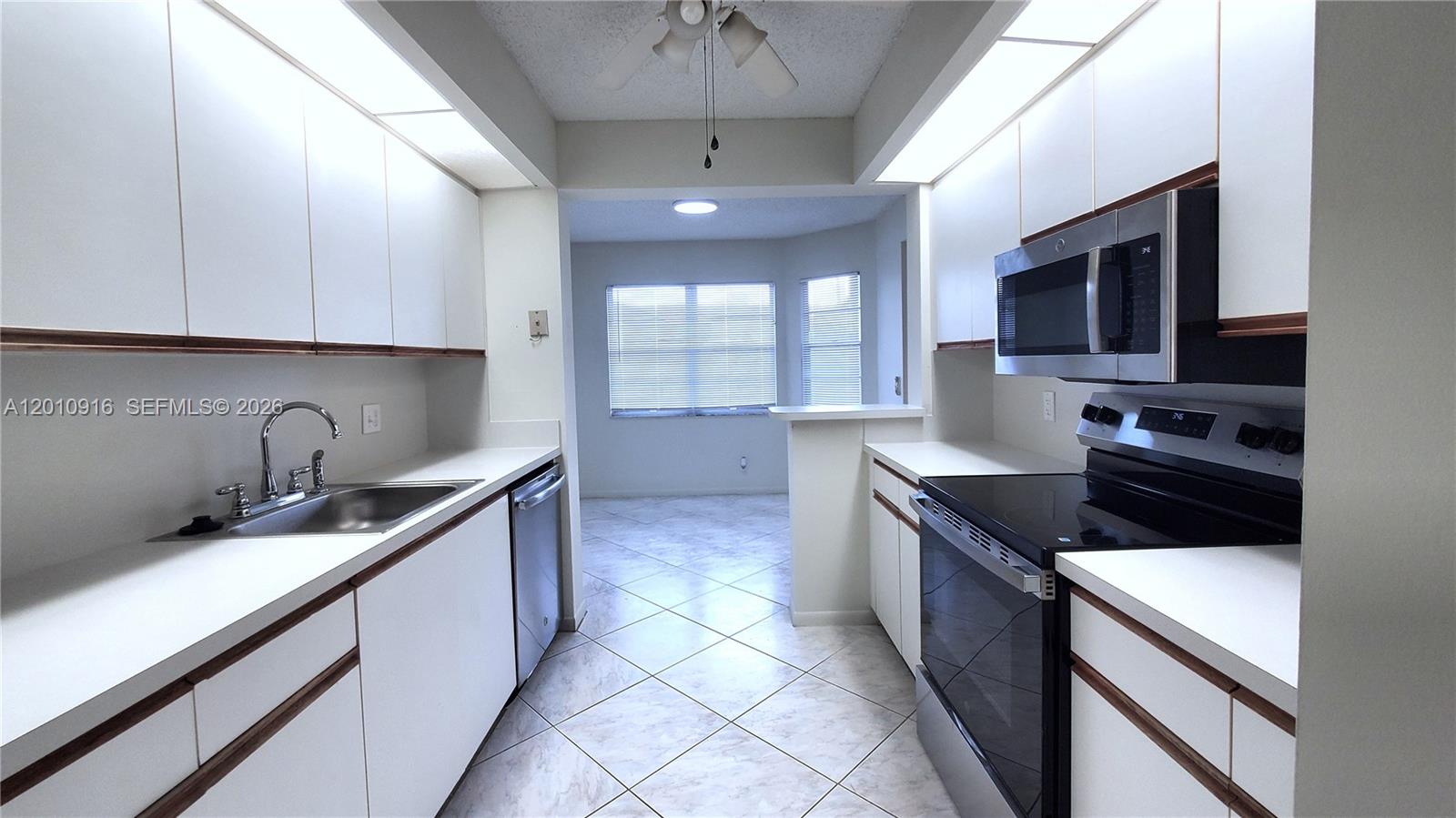 Move-in-ready 2-bedroom, 2-bathroom condo located in the highly desirable community of Century Village at Pembroke Pines. This freshly painted unit features brand-new stainless-steel appliances, new kitchen counters, tile floors throughout, and an enclosed balcony/sunroom offering picturesque views of the golf course.  Equipped with central A/C (less than six years old), the convenience of in-unit washer and dryer, the security of accordion hurricane shutters, and the ease of access via the building’s elevator. Spacious primary bedroom has an ensuite bathroom, and both bedrooms feature large walk-in closets.  Enjoy a resort lifestyle in one of the most prestigious 55+ communities in Southwest Broward. Community amenities include a multi-million-dollar clubhouse, state-of-the-art theater, 18-hole golf course, multiple swimming pools, fitness center, tennis and pickleball courts, movie theater, organized clubs and activities, café, guard gate, 24-hour security patrol, courtesy shuttle transportation, and much, much more. Close proximity to major highways means convenient access to shopping, dining, and medical facilities. Easy to view – make an appointment today!