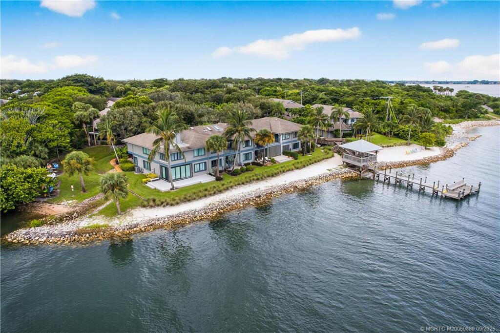 Schooner Oaks is a pet friendly hidden gem which features a clubhouse, pool, tennis courts, sandy beach, fishing pier and is a haven for nature lovers surrounded by scenic public parks. Explore nearby Twin Rivers Park with its waterfront boardwalks, fishing spots, picnic areas & public beach access. This unique condo is in 1 of only 2 buildings out of 21 that are "single level with 2 car garages". Owners take care of "interior only" while HOA fees include roofs, building insurance, lawn, garden, sprinkler system, exterior painting and maintenance. The unit is tiled throughout, and the kitchen has granite countertops and serves through to a huge enclosed tiled rear porch with its own separate a/c. The unit enjoys full accordion shutters along with a hurricane proof skylight. Stroll through  nearby Maggie's Hammock, a dog-friendly park with shaded trails & a playground, Come and enjoy the Good Life in this laid-back waterfront community!