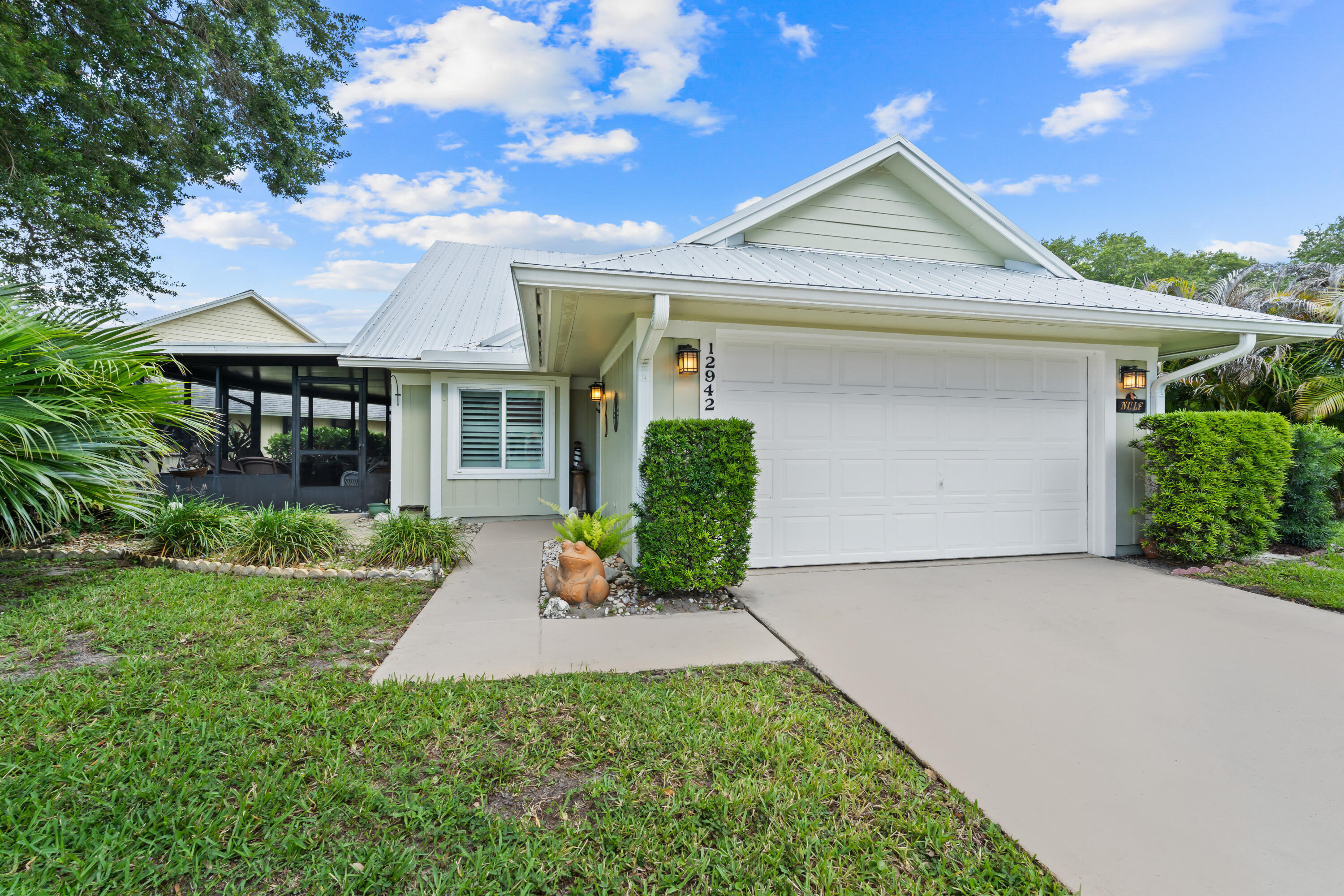 Beautifully and completely updated, this one-of-a-kind home showcases exceptional quality and attention to detail. Featuring stunning high-end ceramic tile flooring, cathedral ceilings, crown molding, and 6-inch baseboards, this residence offers both elegance and comfort. The gourmet kitchen and updated baths include beautiful wood cabinetry, granite countertops, and top-of-the-line newer appliances. Major updates include a metal roof  and AC (2021), and new sprinkler system (2025). Exterior walls are finished with durable Hardy Board siding. Impact Windows. Additional highlights include plantation shutters, 31x 11 screened patio, laundry area with washer, dryer and sink, plus an air-conditioned garage. HOA fees include golf, tennis, pool and clubhouse for the ultimate Florida Lifestyle. Capital Contribution 2 % of Purchase Price, Unlimited Golf.