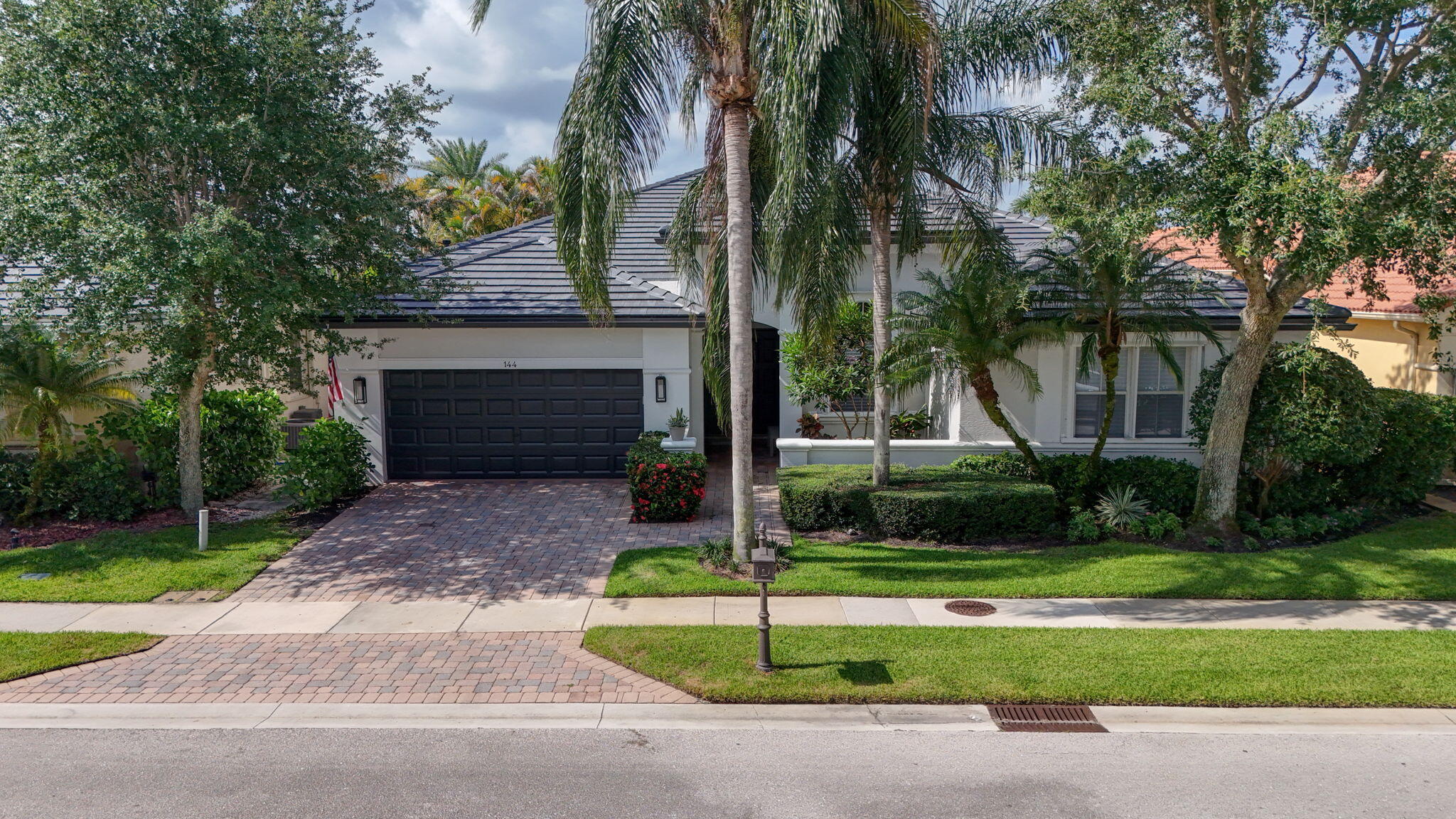 Welcome to this stunning waterfront & single-story residence in Mirabella w/Southern Exposure & long lake views from a large screened-in patio & full-sized heated pool & expansive patio & large covered lanai.  Owner made into 4 BR plus off/flex space &  3 Baths. New flat Tile modern roof, new gutters, and updated exterior all in 2026. Renovated kitchen with contemporary Euro cabinetry, quartz countertops, and updated appliances. Designer finishes and upgrades throughout, including Saturnia Marble Flooring & nice luxury vinyl flooring in all bedrooms, nice molding, and window treatments.  Rare opportunity for a house this nice in Mirabella, one of the best gated resort-style premier communities in the heart of PBG close to everything.  Mirabella is one of the nicest communities in all of the northern Palm Beaches with a a24/7 manned guard gate.  Features a clubhouse with a nice fitness center and yoga stretch room, card, and social areas, and a resort-style heated pool.  Four Tennis Courts & a Kids Clubhouse and Playground on the property management and more, and nestled in the perfect location , convenient to all highways, shopping, great world-class golf, tons of shopping, downtown area, and restaurants all minutes away.