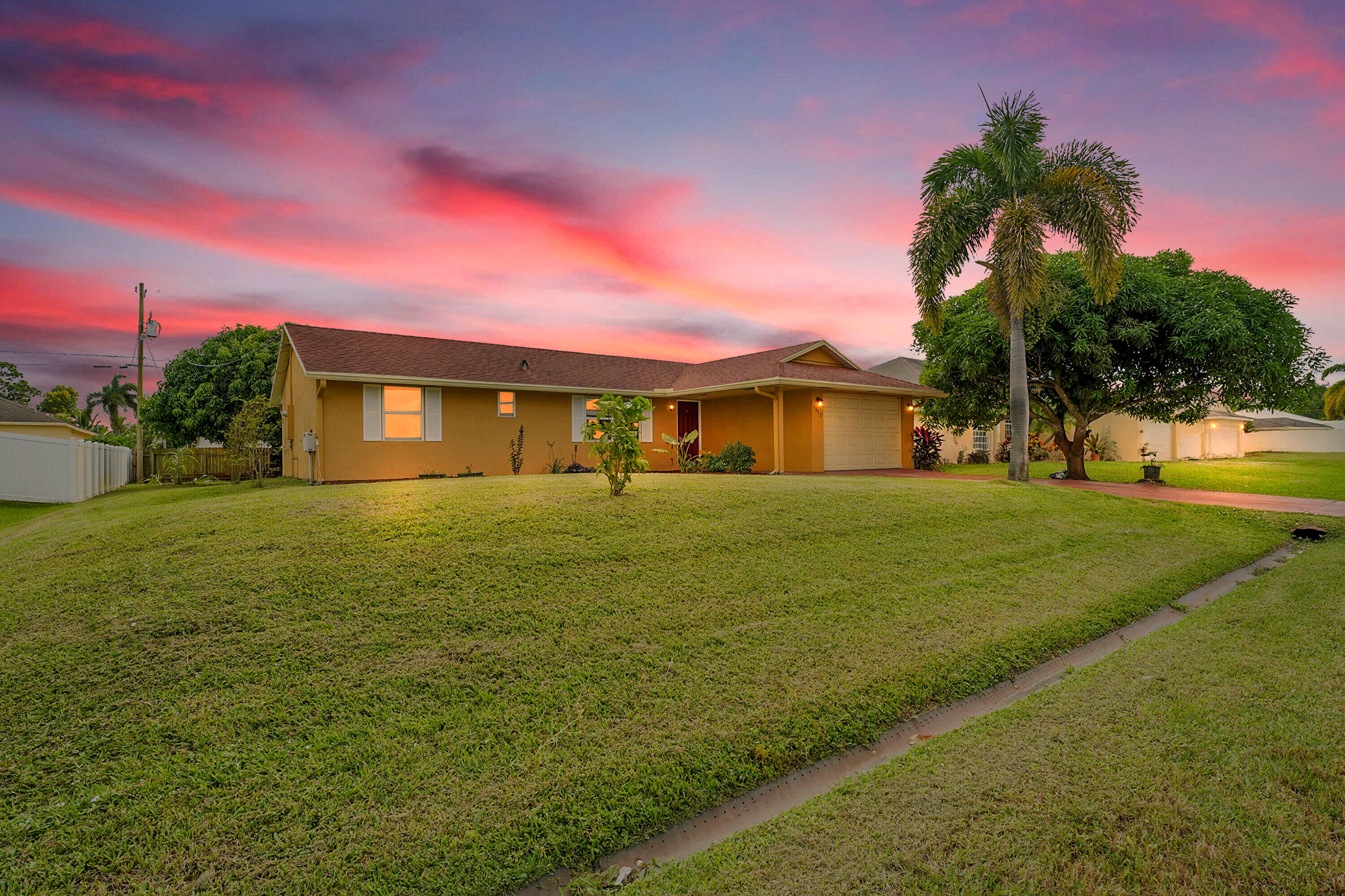 Welcome to your new home a beautifully maintained 3 bedroom, 2 bathroom residence with a spacious garage and an oversized back yard that is a gardener's dream! You will love the abundance of fruit trees offering a private oasis right in your own yard. Located off Rosser south of Gatlin this home sits in one of the most desirable areas in Port St Lucie, Just minutes from Tradition, shopping, dining, parks, and I-95 for easy commuting. Step inside and you will find a bright open floorplan that's completely move-in ready perfect for anyone looking for a low maintenance Florida lifestyle. Homes like this don't come around often and they don't last long. Schedule your private showing today before it's gone!