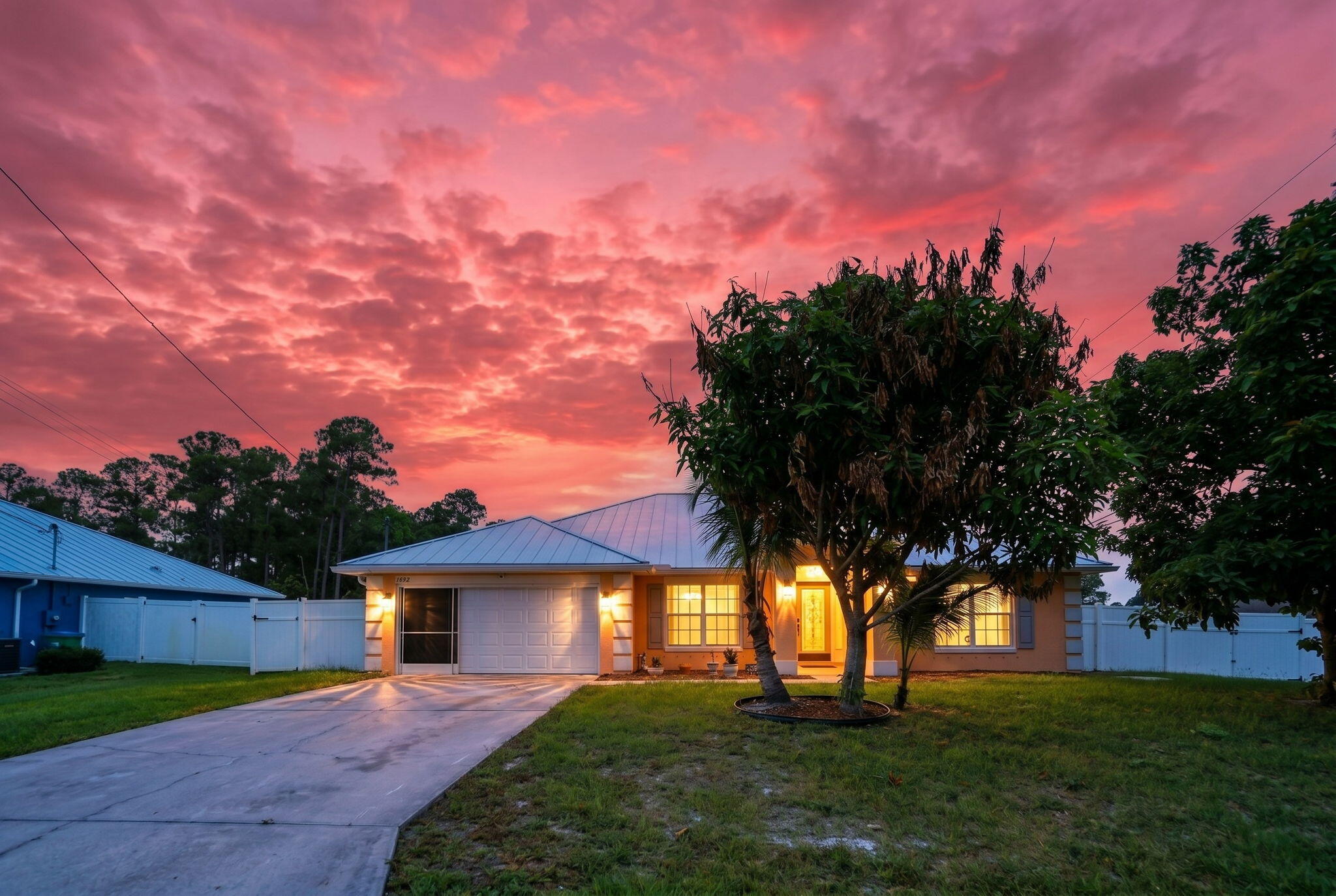Spacious 4-bedroom, 3-bath home ideally located just minutes from the heart of Tradition. Major updates have already been completed, including a newer HVAC system and a metal roof installed in 2023.  Inside, you'll find a wide open floor plan with formal living and dining areas accented by porcelain tile flooring with decorative border inlays. The generously sized kitchen offers abundant cabinetry and counter space and opens seamlessly to the large family room, creating an ideal setting for entertaining and everyday living. Tile flooring extends throughout the entire home for easy maintenance. You will love the large primary suite with a walk-in closet, a garden tub, and a separate shower.  The expansive primary suite features a large ensuite bath and walk-in closet. All guest bedrooms large with ample closet space. Step outside to enjoy the privacy-fenced backyard with plenty of room for pets, play, or future enhancements. Big two-car garage and large corner lot! Conveniently located near shopping, dining, medical facilities, and with easy access to I-95, this property combines space, location, and opportunity.