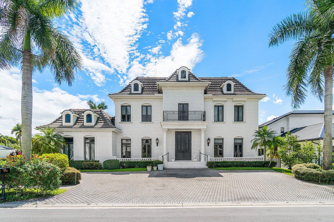Experience unparalleled luxury in this extraordinary custom European estate, ideally situated within the highly sought-after Boca Grove Country Club. Boasting over 7,800 square feet of meticulously designed living space, this six-bedroom, eight-bathroom masterpiece showcases the finest finishes for the most discerning buyer. From the moment you enter, you are greeted by a dramatic custom iron staircase and exquisite Thassos marble and black granite floors, setting the tone for refined elegance throughout the home.The heart of the residence is a high-end kosher Neft chef's kitchen, featuring two sinks, two dishwashers, an oversized premium Sub-Zero refrigerator, and a full suite of Miele and Thermador appliances. A spacious walk-in pantry completes the space, offering exceptional functionality. The expansive family room includes a working fireplace and flows seamlessly into the home's elegant entertaining spaces. The formal dining room comfortably accommodates more than twenty guests and features three hidden closets, making it ideal for hosting holidays and large gatherings. A fully equipped wine room includes a beverage refrigerator, wine refrigerator, sink, and additional storage. The first floor also offers three spacious ensuite bedrooms along with a private theater room. Upstairs, the primary suite is truly one of the most impressive you will encounter, offering over 2,200 square feet of private living space. This extraordinary retreat includes separate his-and-her bathrooms, expansive custom closets, and direct access to a 320-square-foot private sun deck with artificial turf and tranquil zen-inspired details overlooking the lake and golf course. Two additional upstairs bedrooms are currently configured as a fully equipped gym and an elegant library and billiard room. The outdoor living area is designed for year-round enjoyment, featuring a resurfaced pool, abundant covered seating areas, a built-in summer kitchen, that create a true resort-style atmosphere. Additional highlights include a Crestron smart home system, full impact glass windows and doors, a generator servicing the first floor, a private elevator, and countless other luxury upgrades. If you are seeking a residence defined by impeccable craftsmanship and uncompromising luxury, this remarkable estate delivers on every level. Schedule your private showing today and experience Boca Grove living at its finest.