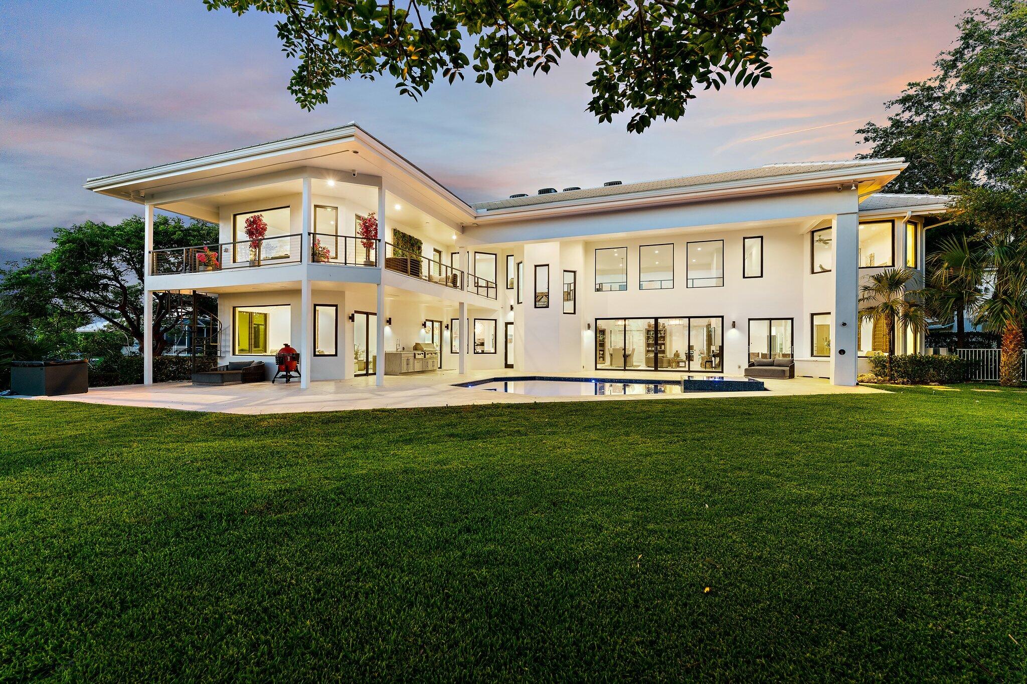Experience exceptional waterfront living in this beautifully updated estate with sweeping wide-water views from nearly every room. The expansive floor plan features grand living spaces, two luxurious primary suites, and a stunning chef's kitchen with marble countertops and backsplash, a large center island, Wolf range, Sub-Zero refrigerator, and two dishwashers. Designed for seamless indoor-outdoor living, this waterfront retreat includes a resort-style pool and spa, summer kitchen, and multiple entertaining areas. Nearly 300 feet of waterfront frontage offers a private teak dock, 20,000-pound boat lift, underwater lighting, and convenient ocean access. Extensively upgraded with four new A/C, whole-home air purification system, enhanced pool equipment, custom California Closets. designer lighting, security cameras, and more, this turn-key estate delivers the ultimate South Florida waterfront lifestyle.