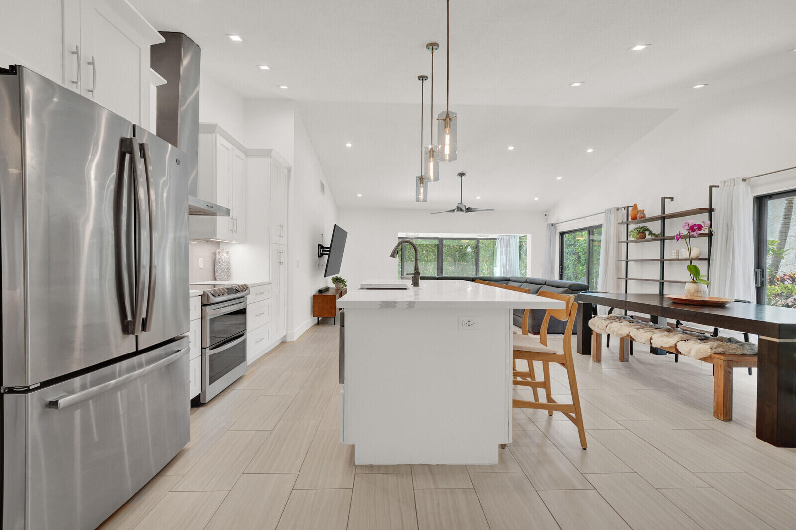 Every major upgrade has been completed! This home is move in ready.  2019 roof, 2023 Bosch A/C with smart thermostat, 2022 smart water heater, and impact windows, doors, and oversized slider. The enclosed rear porch with floor-to-ceiling hurricane impact glass adds valuable living space filled with natural light.  Remodeled bathrooms include a luxurious primary bath with a two-person shower, dual shower heads, double vanity, and custom tower. Additional highlights include custom closets, over 40 recessed LED lights with dimmers, Ring security cameras, MyQ smart garage system, generator transfer switch, and a 2025 W/D. Gated community features 2 pools, tennis/pickle ball court, basketball court, and 25 acre lake that connects to Lake Ida. 3 miles from beaches and trendy Atlantic Ave.