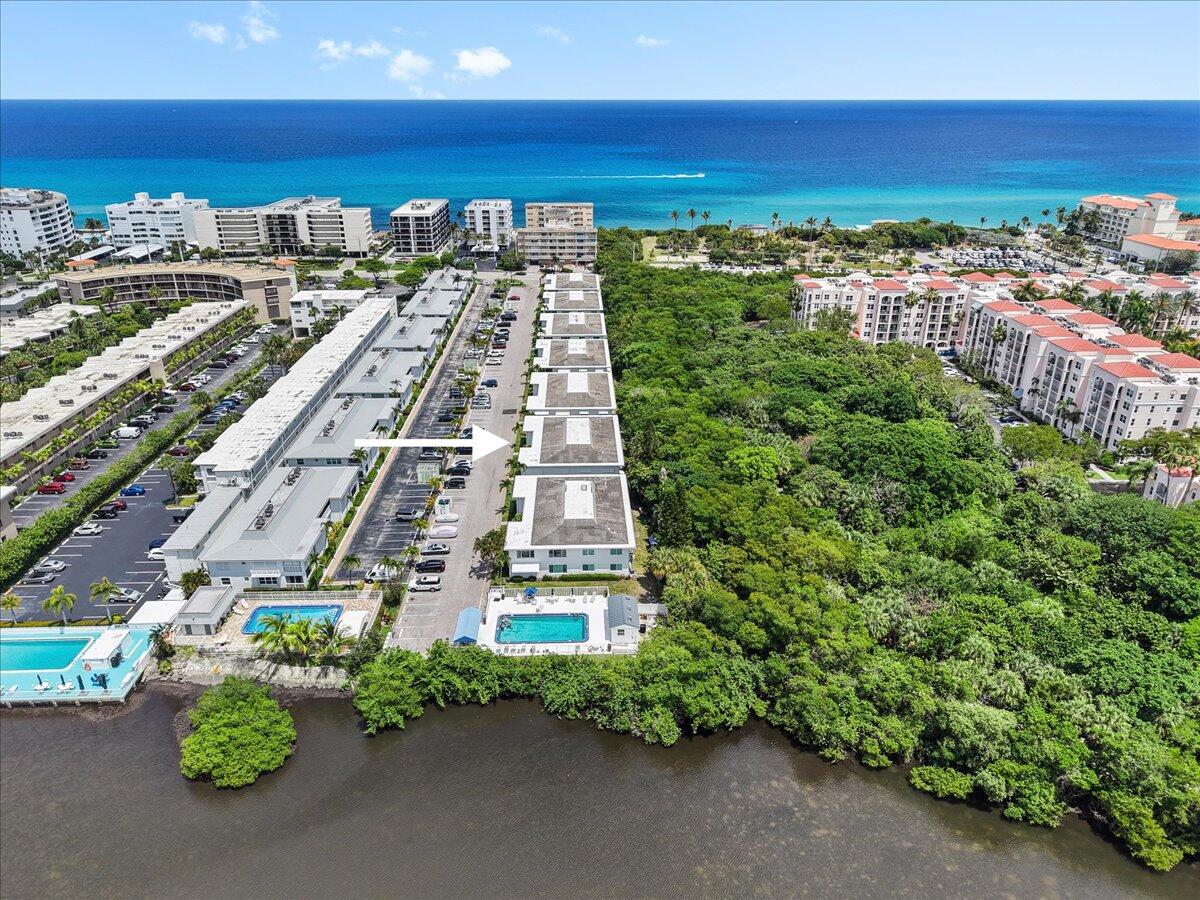 Live Your Beach Dream! Welcome to this beautifully updated coastal condo, perfectly situated just steps from the beach and pool in a charming two-level building. Enjoy the ultimate Florida lifestyle with a front patio and outdoor space ideal for grilling, or simply soaking in the sun. Backing to the lush greenery of a serene nature preserve and walking path, this home offers both privacy and a tranquil escape.  Inside, you'll find sun-drenched living spaces filled with natural light, featuring upgraded closets, a custom walk-in pantry, and impact-rated hurricane windows and sliding doors for peace of mind. The thoughtfully designed layout makes the most of every inch, blending comfort and functionality. Leave the car behind—this prime location is just steps to a grocery store, multiple ... eateries, an ice cream shop, and the world-famous Eau Palm Beach Resort & Spa. Whether you're seeking a full-time residence or a beachside getaway, this is coastal living at its best