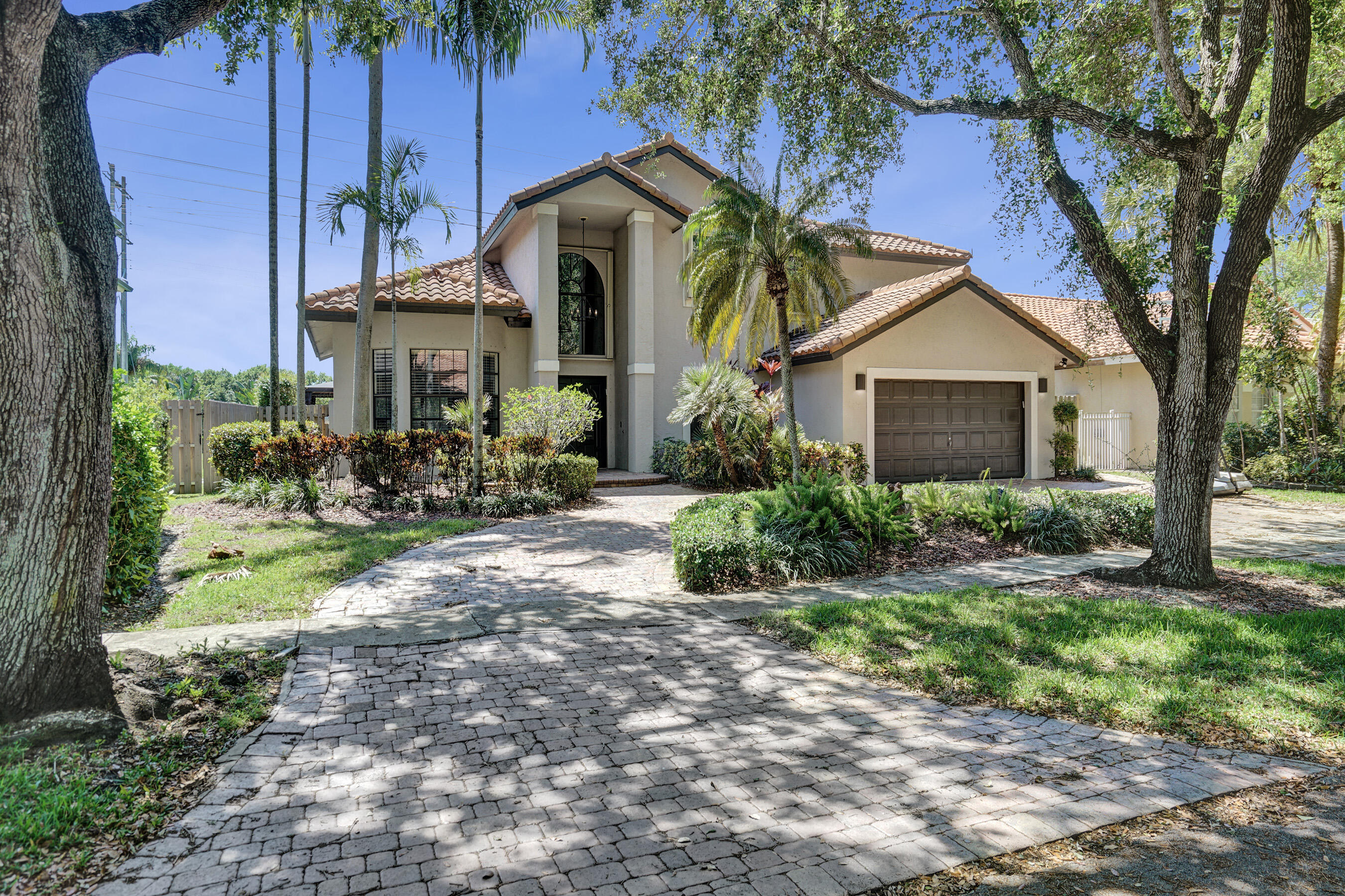 Someone made it a dream home, upgraded it & now it is your turn to enjoy it. Welcome to Embassy Lakes gated community, where this home stands tall & proud on a beautiful tree lined street. Double front doors open to a grand staircase & soaring ceilings that make one thing clear, this is not your average listing. 4 beds, 1 downstairs, & a primary suite with two walk in closets & room to add a balcony overlooking the pool. You are welcome. Saltwater pool, screened patio & covered summer kitchen with a bar; Your guests will never want to leave & honestly, neither will you. The home also has newer electrical panel, water heater, piping, accordion shutters & EV charging station. The expensive stuff is done & the only thing left is deciding when to move in. A rated schools & great amenities.