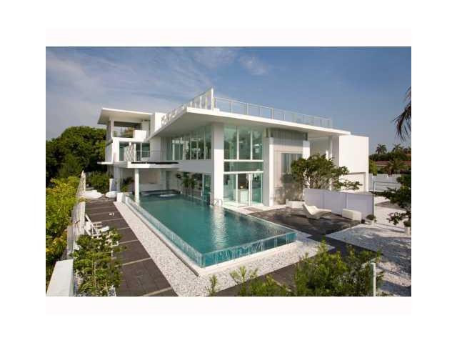 Words cannot describe this magnificent & unique home in sought after GOLDEN BEACH. Must see to fully appreciate this GEM of architecture & living experience. 3 incredible floors of delight with 7 bdrms and 9 bthrms, elevator, ocean views, waterfall, reflective pond, and open & private layout, private office & room for gym/studio/AV room & impact windows. Beach access, tennis, volleyball and basketball courts. Children and pets park, private police. House has been renovated and upgraded with state of the art "smart house" technology. Floors have been polished. Brand new furniture and furnishings. Control the ACs, Pool, Surround sound, Cameras, doors, garage and gate right from you phone or Tablet. Selling under market value. Make offer. Motivated seller.